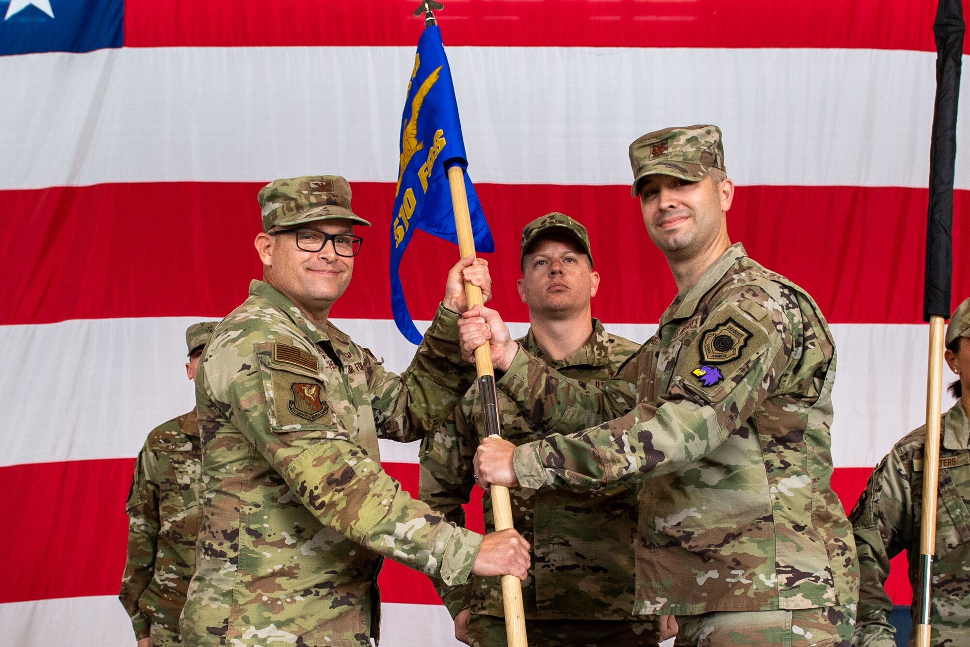 U.S. Air Force Col. Jason Mitchell, 31st Maintenance Group commander, left, presents the 510th Fighter Generation Squadron guidon to U.S. Air Force Maj. Timothy Aanerud, 510th FGS incoming commander
