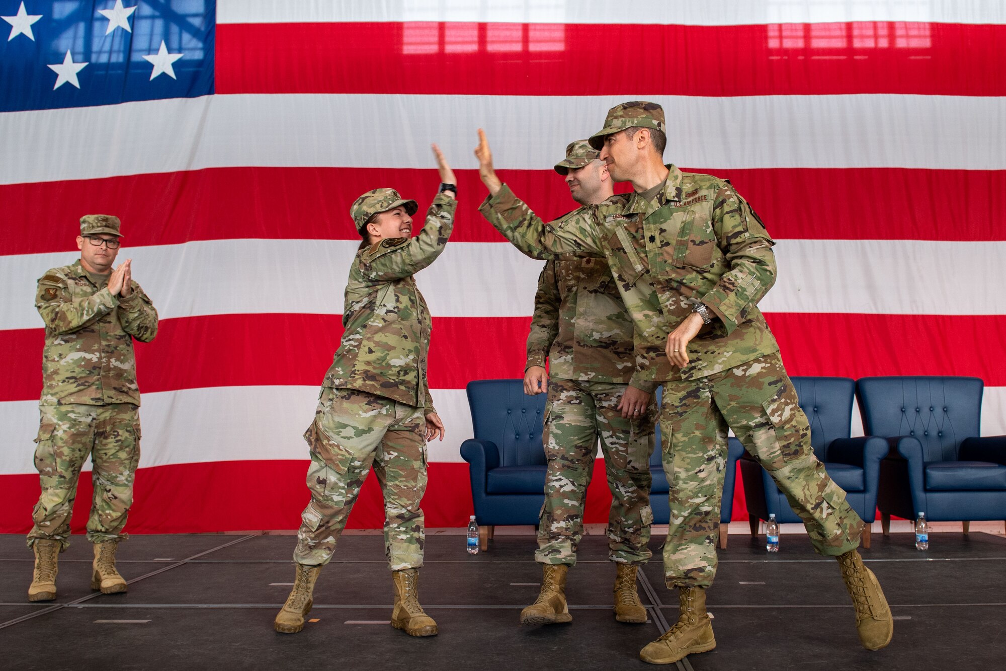 U.S. Air Force Capt. Casey Schindling, 56th Rescue Generation Squadron incoming commander, left, U.S. Air Force Maj. Timothy Aanerud, 510th Fighter Generation Squadron incoming commander, middle, and U.S. Air Force Lt. U.S. Air Force Col. David Liberti, 555th Fighter Generation Squadron incoming commander, right, celebrate after their new squadrons are activated