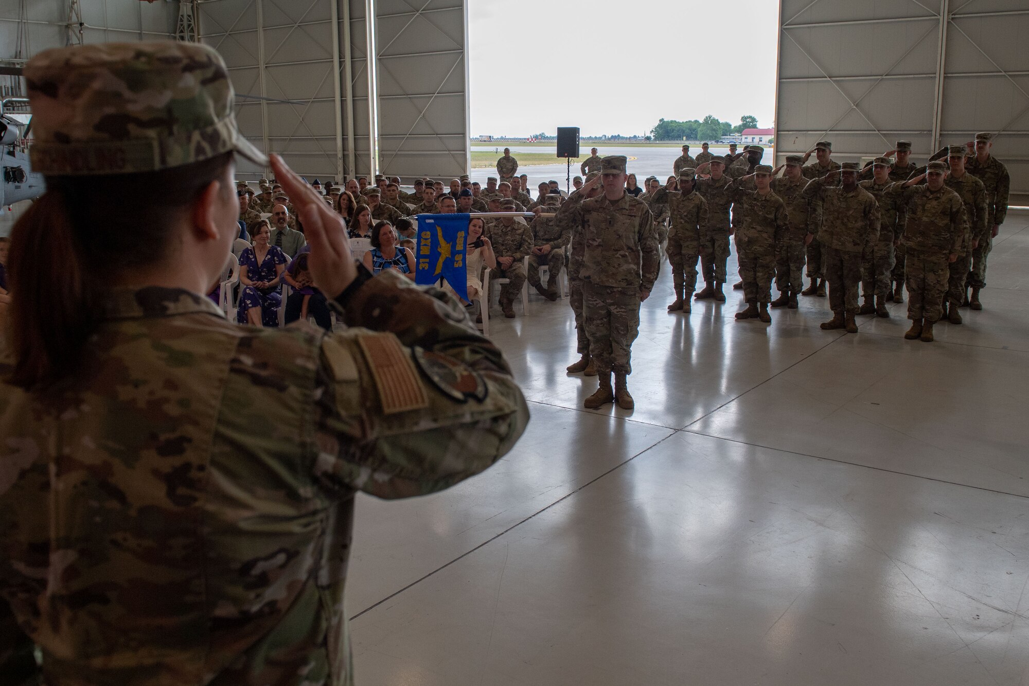 U.S. Air Force Capt. Casey Schindling, 56th Rescue Generation Squadron incoming commander, accepts her first salute as incoming commander