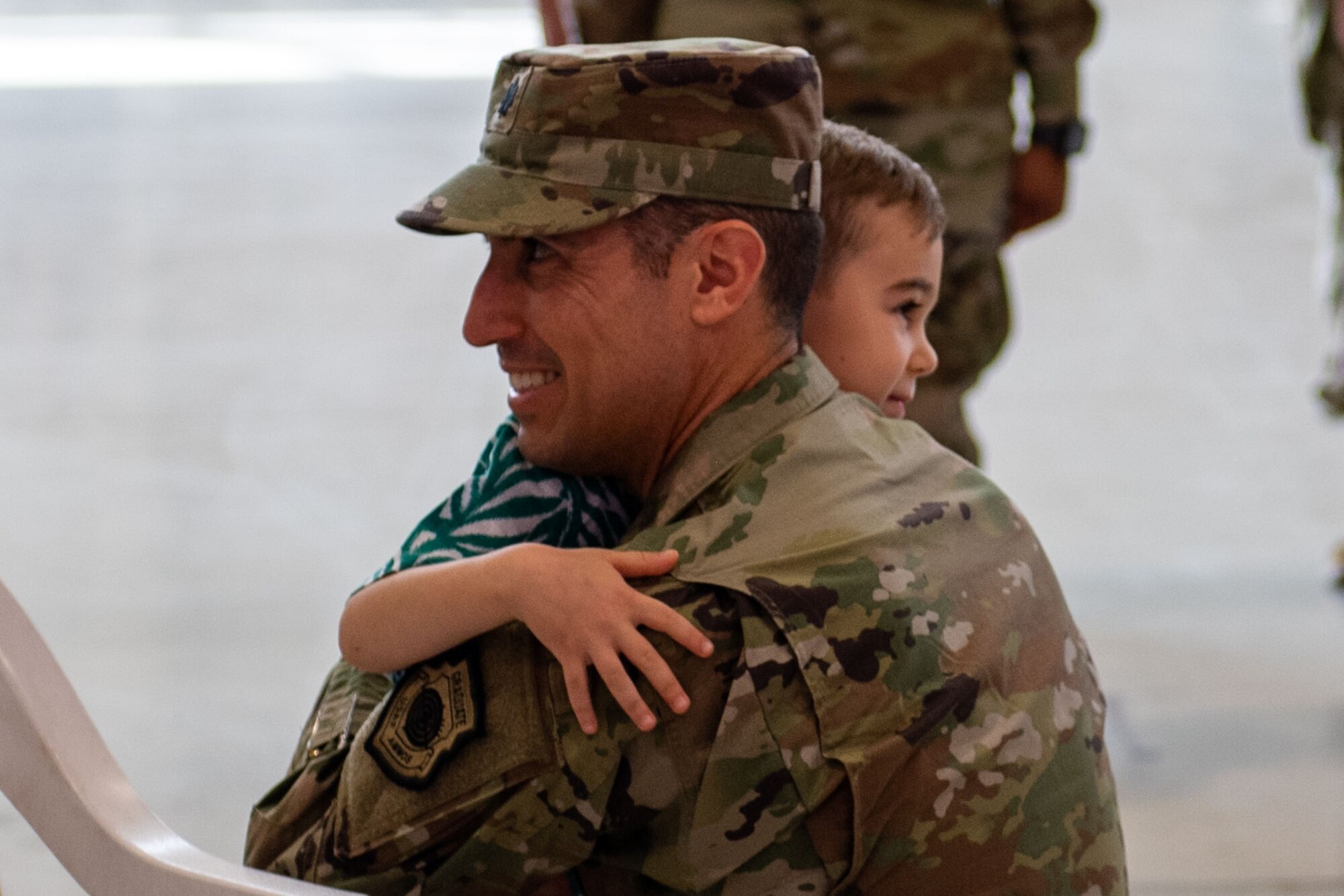 U.S. Air Force Lt. Col. David Liberti, 555th Fighter Generation Squadron incoming commander, hugs his son during the 31st Maintenance Group Reorganization Ceremony