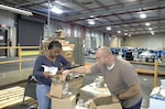 Man and woman work in a warehouse