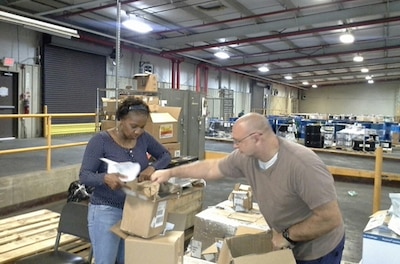 Man and woman work in a warehouse
