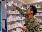 U.S. Navy Hospital Corpsman 3rd Class Michael Rodriguez, from Spring, Texas, assigned to the aircraft carrier USS John C. Stennis (CVN 74), organizes pharmacy medication on the floating accommodation facility, in Newport News, Virginia, May 17, 2022. A Defense Logistics Agency Troop Support Medical team awarded a next generation pharmaceuticals prime vendor contract, on July 14, that will provide additional benefits to military customers and their dependents. (U.S. Navy photo by Mass Communication Specialist 3rd Class Jesus Aguiar)