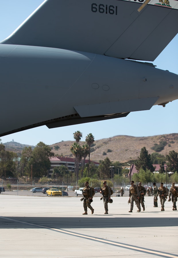 U.S. Marines with 3rd Battalion, 5th Marine Regiment, 1st Marine Division board a U.S. Air Force C-17 Globemaster III aircraft during a joint training exercise on Marine Corps Air Station Camp Pendleton, California, July 25, 2022. This exercise included aircraft from five different U.S. Air Force squadrons and Marines with 3/5, 1st MarDiv to enhance their expeditionary operations in a joint-training environment. This was the first time MCAS Camp Pendleton staged five C-17 Globemaster III aircraft on the air station at one time. (U.S. Marine Corps photo by Cpl. Shaina Jupiter)