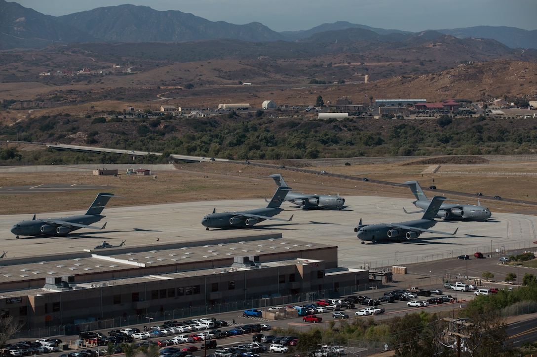 U.S. Air Force C-17 Globemaster III aircraft are staged on a flight line during a joint training exercise on Marine Corps Air Station Camp Pendleton, July 25, 2022. This exercise included aircraft from five different Air Force squadrons and U.S. Marines with 3rd Battalion, 5th Marine Regiment, 1st Marine Division to enhance their expeditionary operations in a joint-training environment. This was the first time MCAS Camp Pendleton staged five Globemaster III aircraft on the air station at the same time. (U.S. Marine Corps photo by Cpl. Shaina Jupiter)