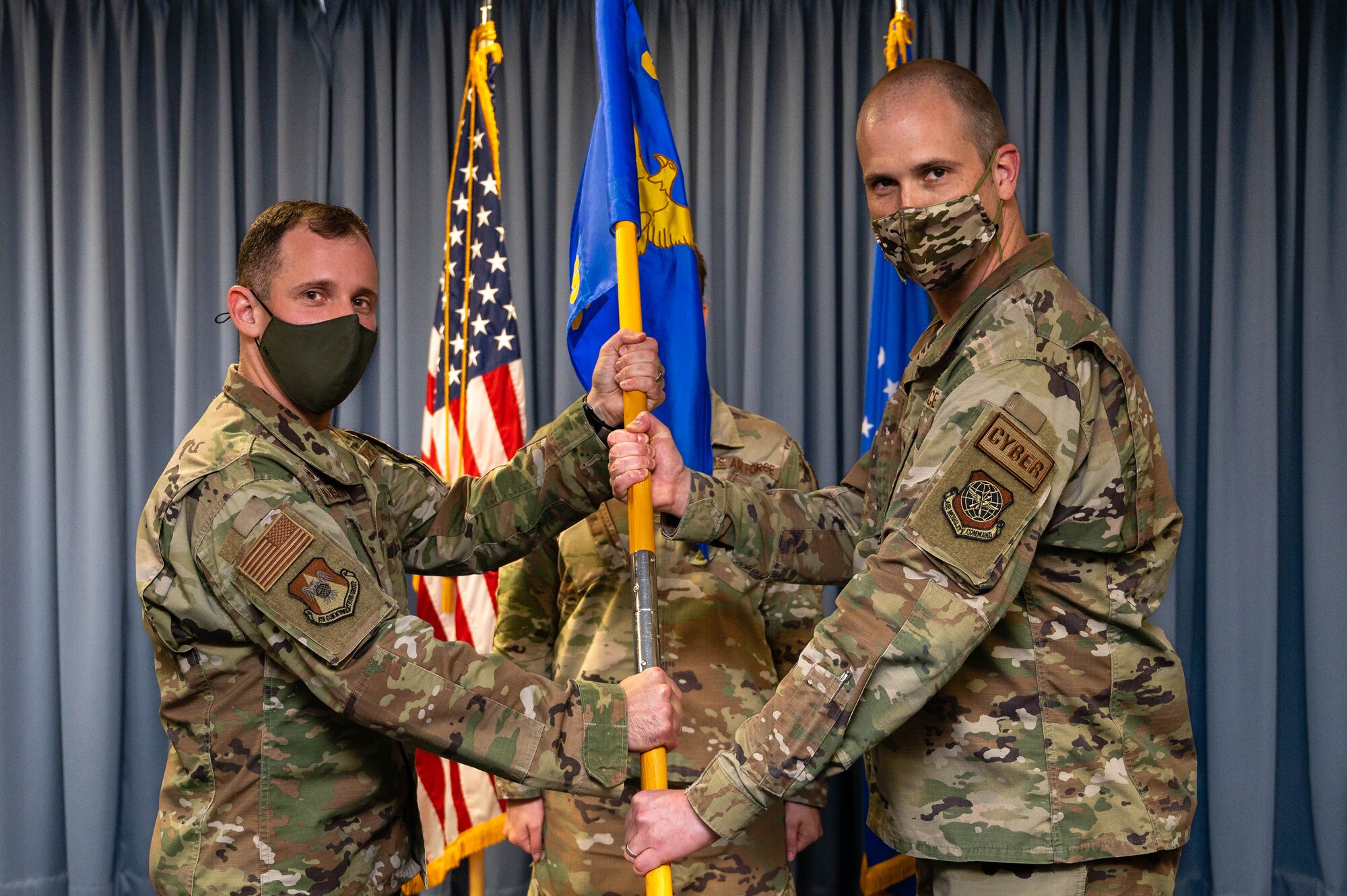 two men hold guidon