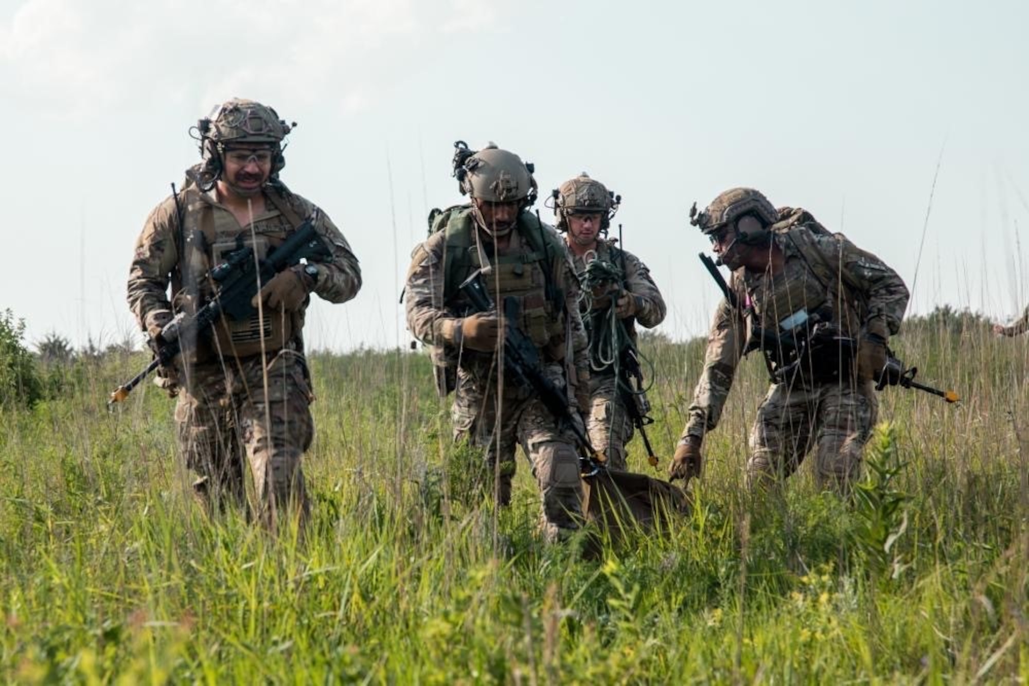 Four Tactical Air Control Party (TACP) Airmen from the 10th Air Support Operations Squadron conduct an area reconnaissance mission as part of joint exercise Gunslinger 22 at Fort Riley Army Post, Kansas, June 24, 2022. Gunslinger 22 integrated U.S. Air Force TACP precision strike team capabilities with U.S. Marine Corps expeditionary air base operations in order to test dynamic force employment options for the supported commander. (Courtesy photo)