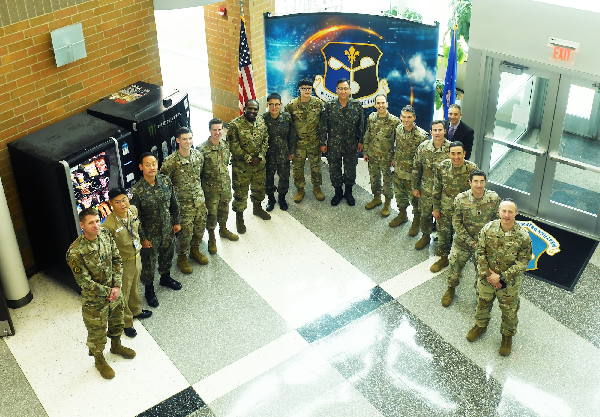 Leadership from the 557th Weather Wing take a moment to have a group photo with their Republic of Korea Air Force Weather Wing counterpart in the atrium of the 557th WW.