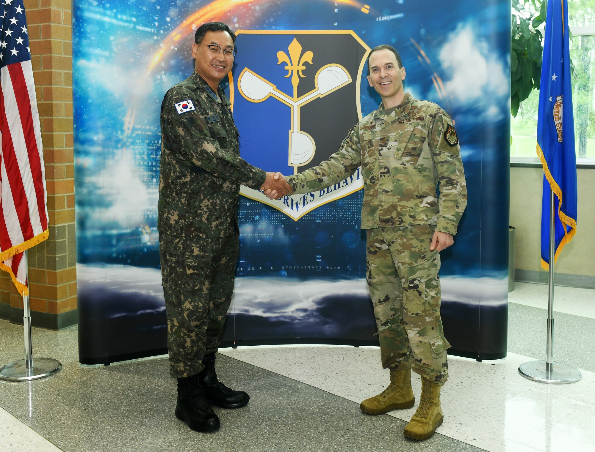 (R to L) Col. Bradley Stebbins, 557th Weather Wing commander, greets Col. Jae Don Hwang, Republic of Korea Air Force Weather Wing commander, to the 557th WW during their visit on May 25, 2022.