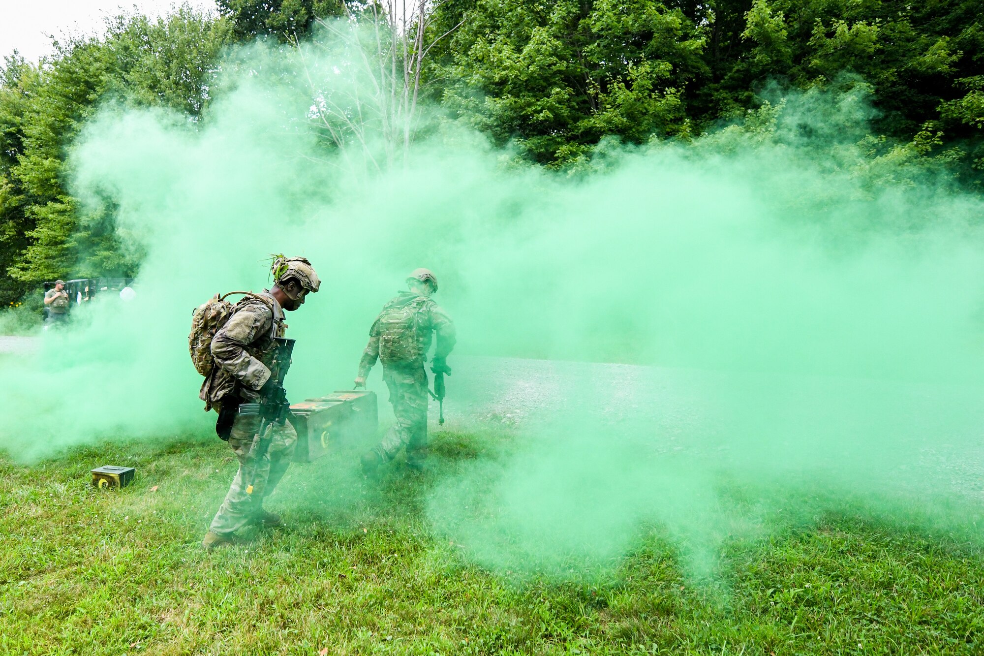Integrated Defense Leadership Course students assigned to the 927th Security Forces Squadron, MacDill Air Force Base, Florida, carry a box of recovered assets after assaulting an opposing force position during an area security operations exercise at Camp James A. Garfield Joint Military Training Center, Ohio, July 27, 2022.