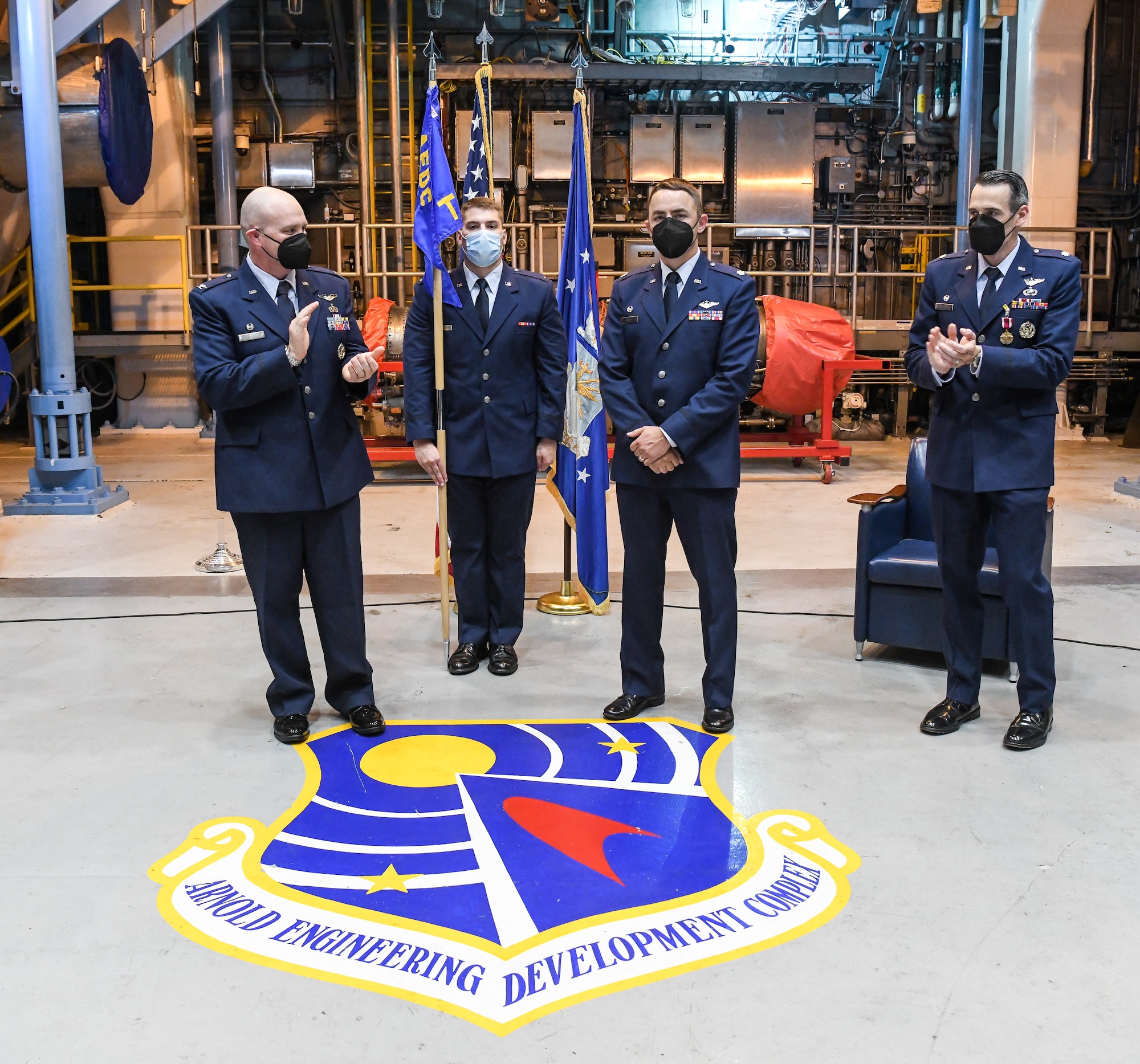 Col. Jason Vap, left, commander, 804th Test Group, and Lt. Col. Lane Haubelt, right, previous commander of 717th Test Squadron, applaud Lt. Col. Ryne Roady, center, after he assumed command of the 717 TS during a change of command ceremony July 8, 2022,