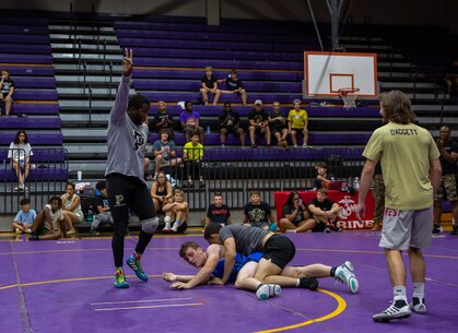 Athletes and coaches participated in a wrestling clinic hosted by Johnson's Athletic Camps and sponsored by the United States Marine Corps at Jack Britt High School in Fayetteville, North Carolina, July 25, 2022.  The clinic provided the opportunity to learn wrestling techniques and leadership development from former All-Marine and University of North Carolina at Pembroke wrestlers.  (U.S. Marine Corps photo by Lance Cpl. Bernadette Pacheco)