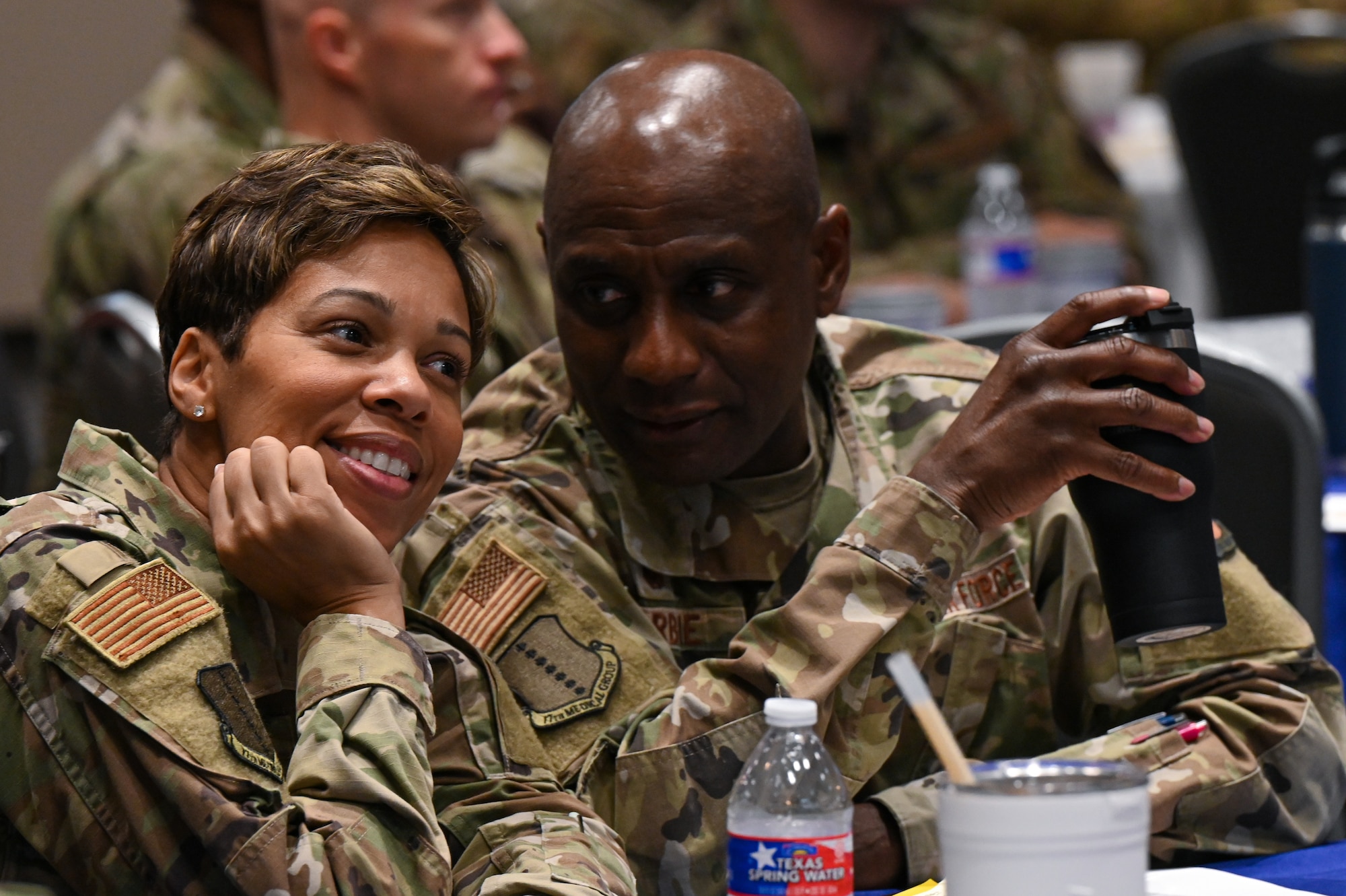 U.S. Air Force Col. Derek Larbie, 17th Medical Group commander, speaks to Chief Master Sgt. Lauren Brock, 17th MDG senior enlisted leader, during the Senior Leader Summit at the Powell Event Center, Goodfellow Air Force Base, Texas, July 26, 2022. The summit was centered around instilling innovation through the 17th Training Wing by demonstrating how the wing accelerates change to empower incoming leadership for success in strategic innovation. (U.S. Air Force photo by Senior Airman Michael Bowman)