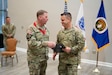 Col. Douglas Copeland, outgoing Project Manager for Soldier Maneuver and Precision Targeting (PM SMPT), turns over the organizational charter to Brig. Gen. Christopher Schneider, Program Executive Officer (PEO) Soldier, during a relinquishment of charter ceremony held on Fort Belvoir, July 14. The ceremony marked the disestablishment of PM SMPT after more than 20 years of providing Soldiers with capabilities designed to enhance lethality, mobility and survivability. (U.S. Army Photo by Jason Amadi, PEO Soldier Public Affairs)