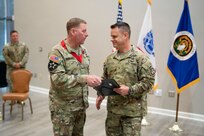 Col. Douglas Copeland, outgoing Project Manager for Soldier Maneuver and Precision Targeting (PM SMPT), turns over the organizational charter to Brig. Gen. Christopher Schneider, Program Executive Officer (PEO) Soldier, during a relinquishment of charter ceremony held on Fort Belvoir, July 14. The ceremony marked the disestablishment of PM SMPT after more than 20 years of providing Soldiers with capabilities designed to enhance lethality, mobility and survivability. (U.S. Army Photo by Jason Amadi, PEO Soldier Public Affairs)