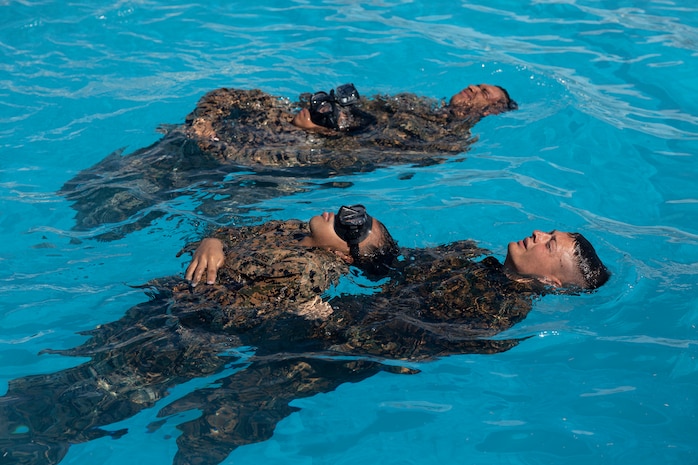 U.S. Marines participating in the Water Survival Advanced course perform rescues on simulated distressed victims during the WSA course on Marine Corps Air Station Futenma, Okinawa, Japan, July 22, 2022. WSA is the highest swim qualification that Marines can obtain before becoming Marine Corps Instructors of Water Survival. Throughout the course, students endured aquatic conditioning, endurance swimming, and underwater rescue training.