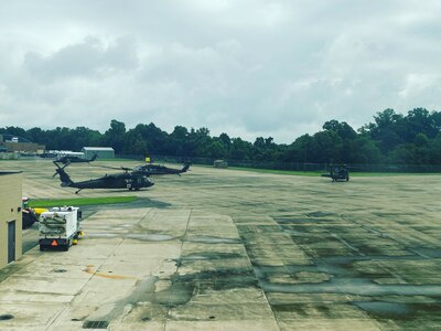 Two West Virginia National Guard UH-60M Blackhawks sit on the tarmac during pre-flight operations at Big Sandy Regional Airport in Pike County, Kentucky, July 29, 2022. Fourteen Soldiers from the WVNG’s Company C, 2-104th General Support Aviation Battalion (MEDEVAC) and Company B, 1-224th Security and Support Aviation Battalion located in Williamstown, West Virginia, flew more than 25 hours July 28, 2022, rescuing over a dozen people and three pets from southeastern Kentucky following catastrophic flash flooding. (courtesy photo)