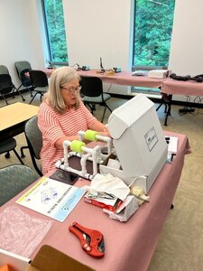 IMAGE: Amy Fitch, a technology education teacher at Prospect Heights Middle School in Orange County constructs a SeaPerch remotely operated vehicle during training July 19 at the University of Mary Washington’s Dahlgren campus.