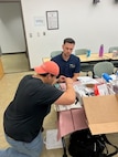 IMAGE: Luis Valcourt-Colon, lead scientist/software developer with the Weapon Control Software Branch at Naval Surface Warfare Center Dahlgren Division, works with Austin Eppenstein, a teacher at Grafton Village Elementary School in Stafford County on the construction of a SeaPerch remotely operated vehicle on July 19 at the University of Mary Washington’s Dahlgren campus.