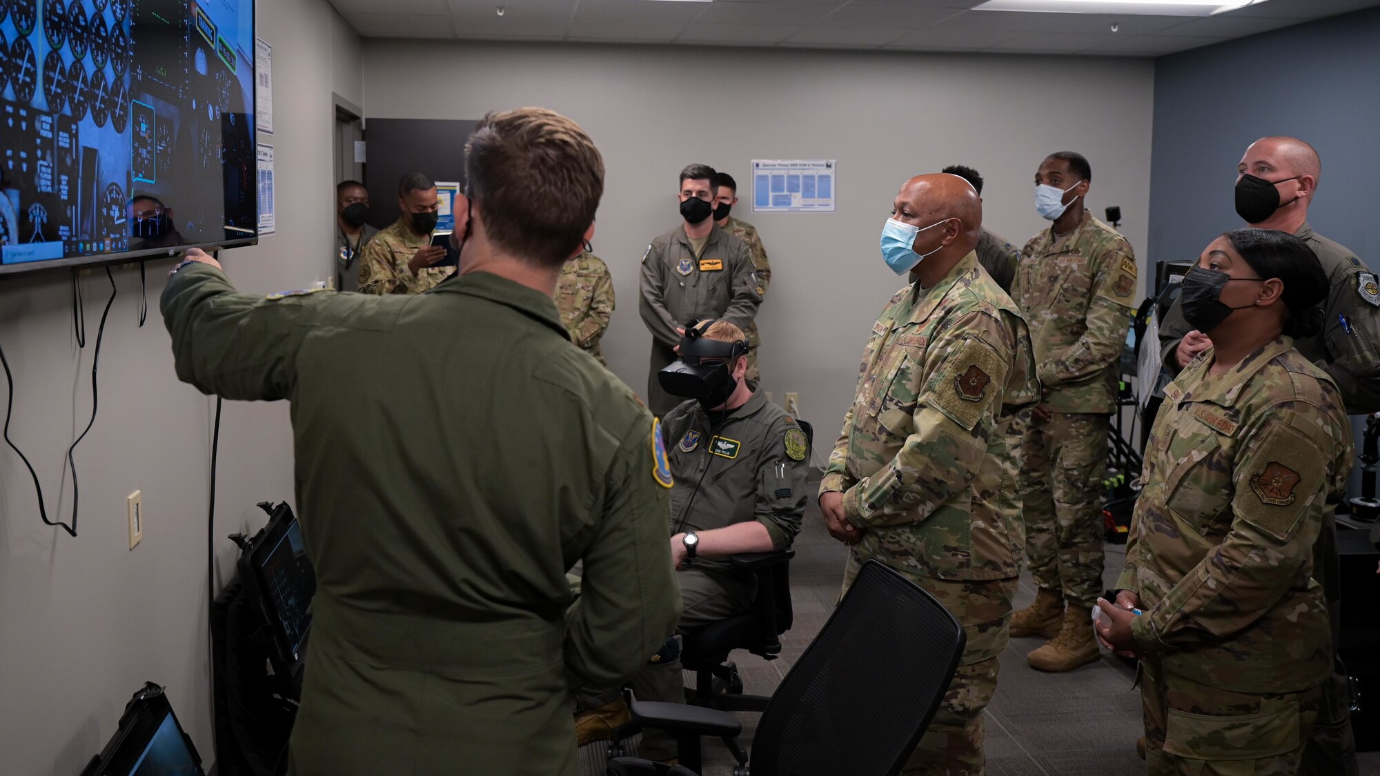 Gen. Anthony Cotton, Air Force Global Strike Command commander, and Chief Master Sgt. Melvina Smith, AFGSC command chief, listen to Maj. Mark Budgeon, 93rd Bomb Squadron, explain the new B-52H Stratofortress cockpit virtual reality trainer during a visit at Barksdale Air Force Base, Louisiana, July 8, 2022. The VR simulator technology aligns with modernization priorities ensuring forces are ready to meet future challenges. (U.S. Air Force photo by Senior Airman Jonathan E. Ramos)