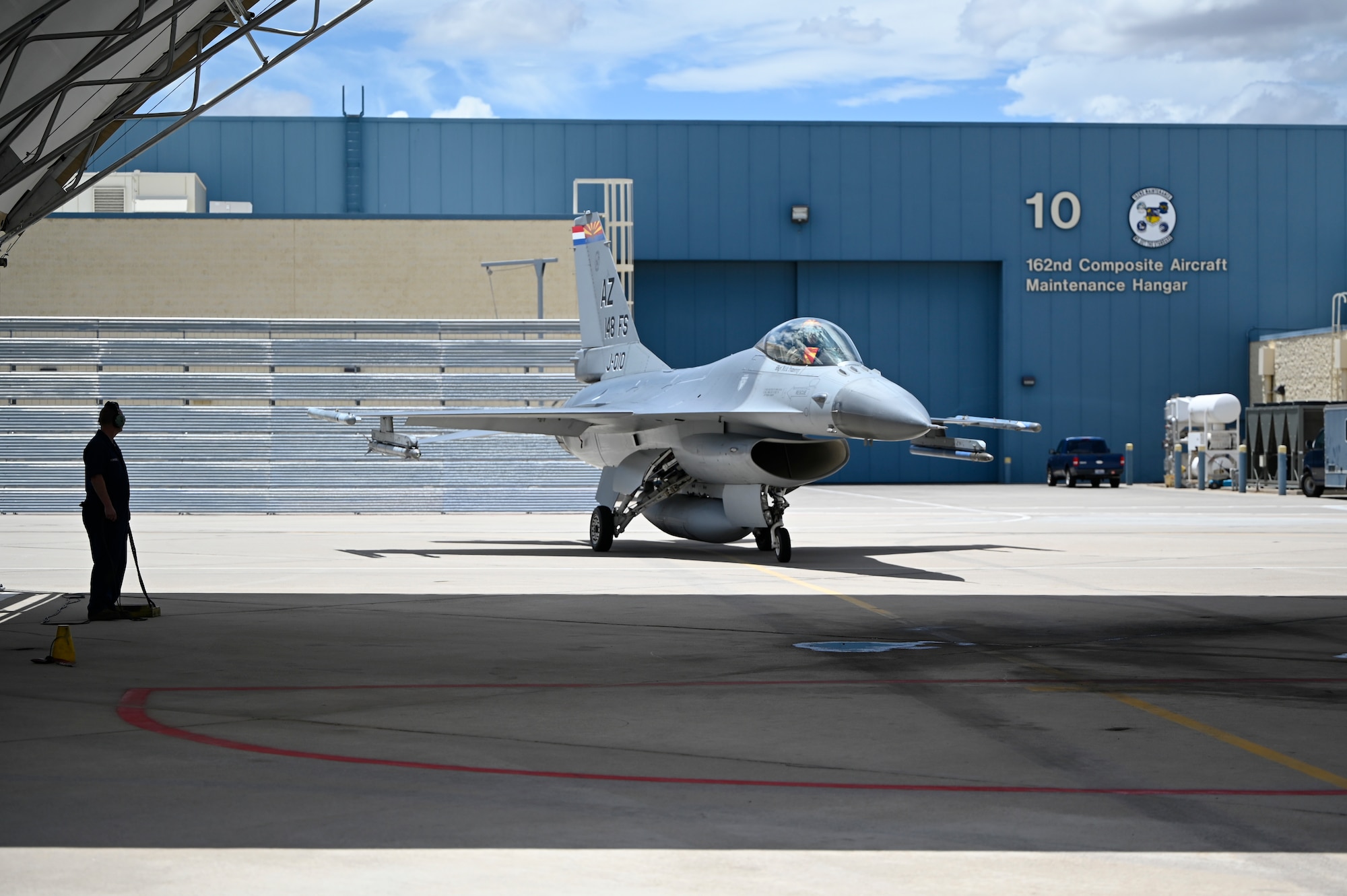 An F-16 crew chief from the 162nd Wing at Morris Air National Guard Base in Tucson monitors an F-16 as it parks before engine shutdown after its final flight today. The RNLAF has commenced transition from the F-16 to the F-35. (U.S. Air National Guard photo by Maj. Angela Walz)