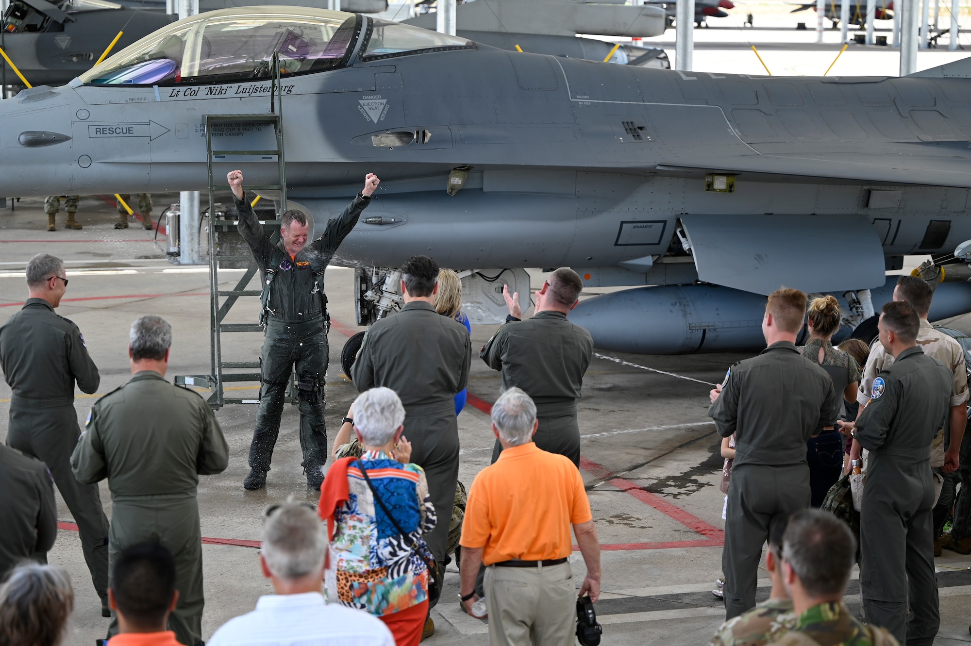 Lt. Col. Joost Luijsterburg, the Royal Netherlands Air Force detachment commander, is sprayed with water after completing his final flight in an F-16 at the Morris Air National Guard Base. Luijsterburg has already assumed command of the Dutch F-35 detachment at Luke Air Force Base, Arizona, and has been acting as dual commander of both detachments. (U.S. Air National Guard photo by Maj. Angela Walz)