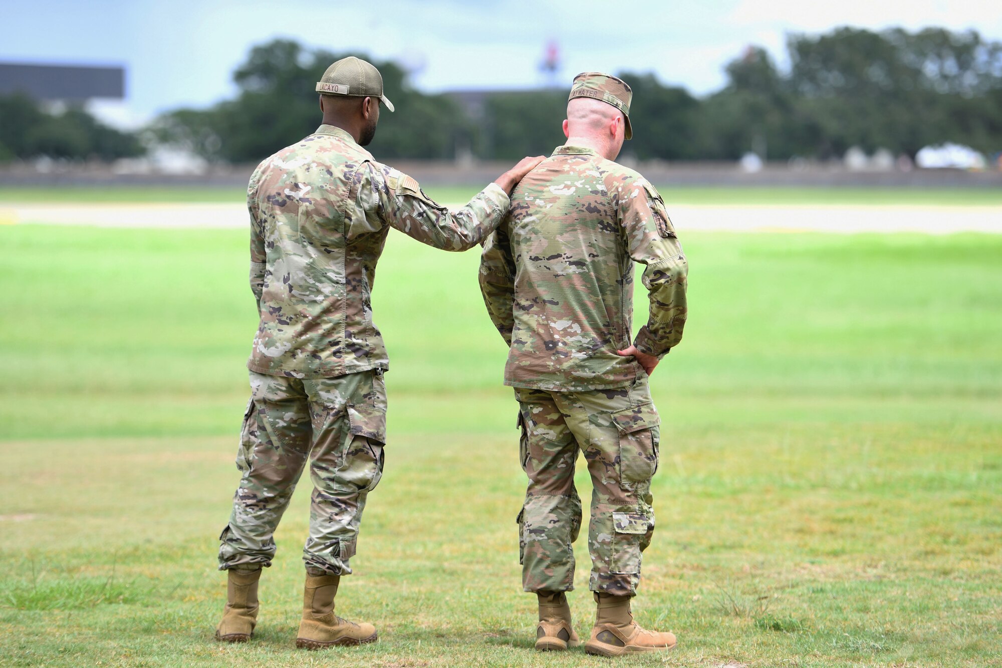 Keesler Airmen take a moment during a remembrance ceremony for Airman Daniel Germenis at Keesler Air Force Base, Mississippi, July 28, 2022. Germenis, who was assigned to the 336th Training Squadron, was remembered by members of the 81st Training Group on the one year anniversary of his passing. (U.S. Air Force photo by Kemberly Groue)