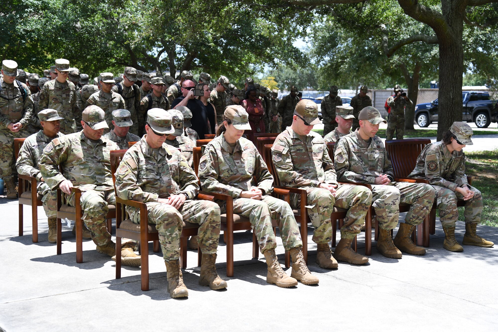 Keesler personnel take a moment of silence during a remembrance ceremony for U.S. Air Force Airman Daniel Germenis outside of Thompson Hall at Keesler Air Force Base, Mississippi, July 28, 2022. Germenis, who was assigned to the 336th Training Squadron, was remembered by members of the 81st Training Group on the one year anniversary of his passing. (U.S. Air Force photo by Kemberly Groue)