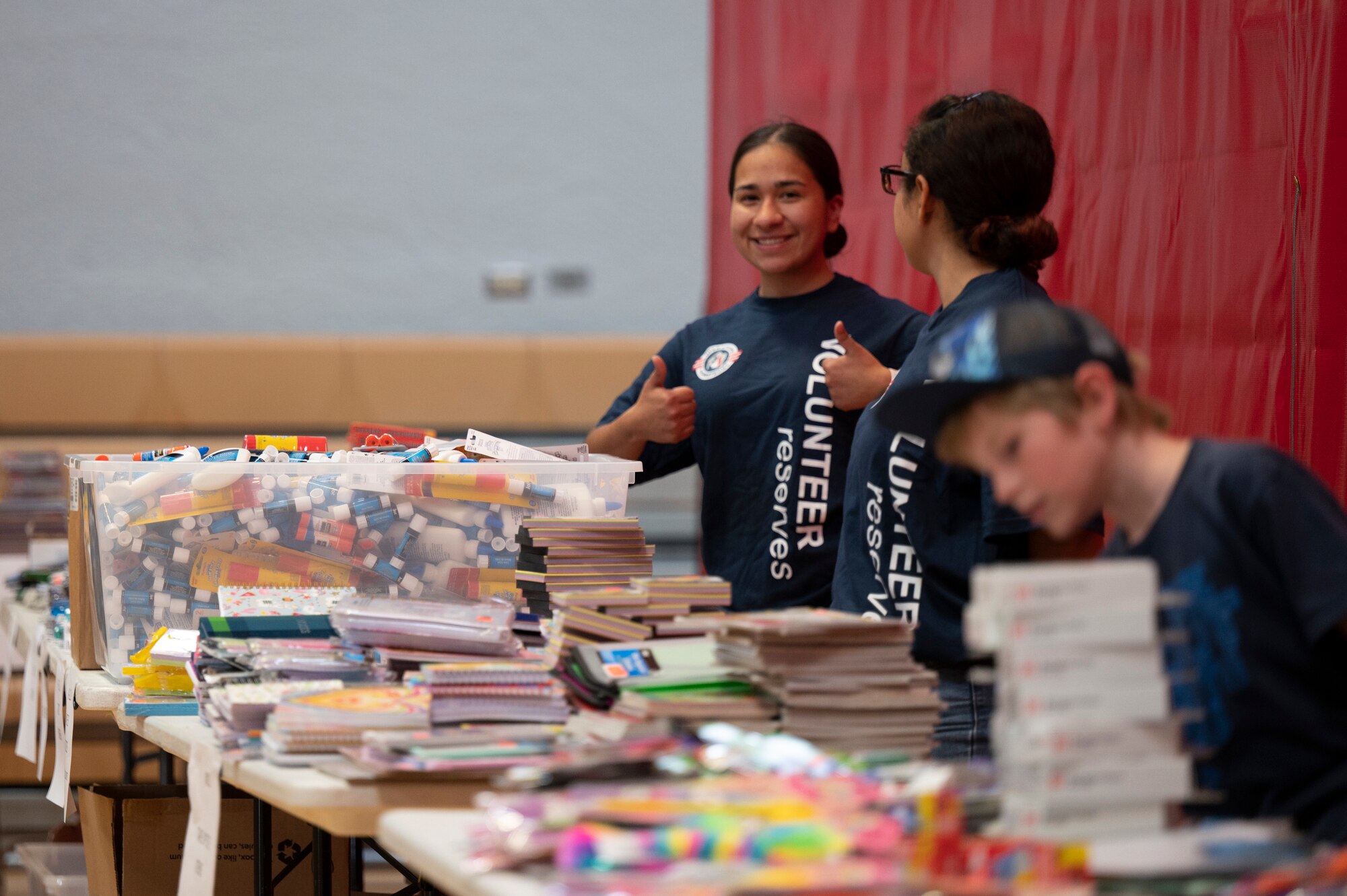 Photo of volunteers handing out school supplies.