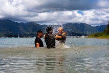 U.S. Marines with Marine Corps Base Hawaii participate in shallow water grappling during a Marine Corps Martial Arts Program culminating event, MCBH, July 28, 2022. The purpose of the culminating event was to challenge and test the course participants on both MCMAP techniques and endurance. (U.S. Marine Corps photo by Lance Cpl. Benjamin Pennisson)