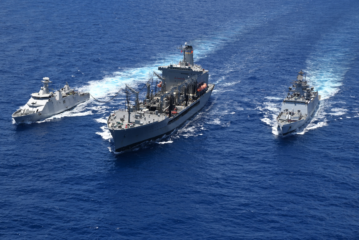 Indonesian Navy frigate KRI I Gusti Ngurah Rai (332), left, Henry J. Kaiser-class fleet replenishment oiler USNS Pecos (T-AO 197), center, and Republic of Singapore Navy guided-missile frigate RSS Intrepid (69) conduct a refueling-at-sea during Rim of the Pacific (RIMPAC) 2022.