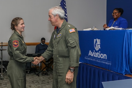 Adm Meier shaking hands with Alison North