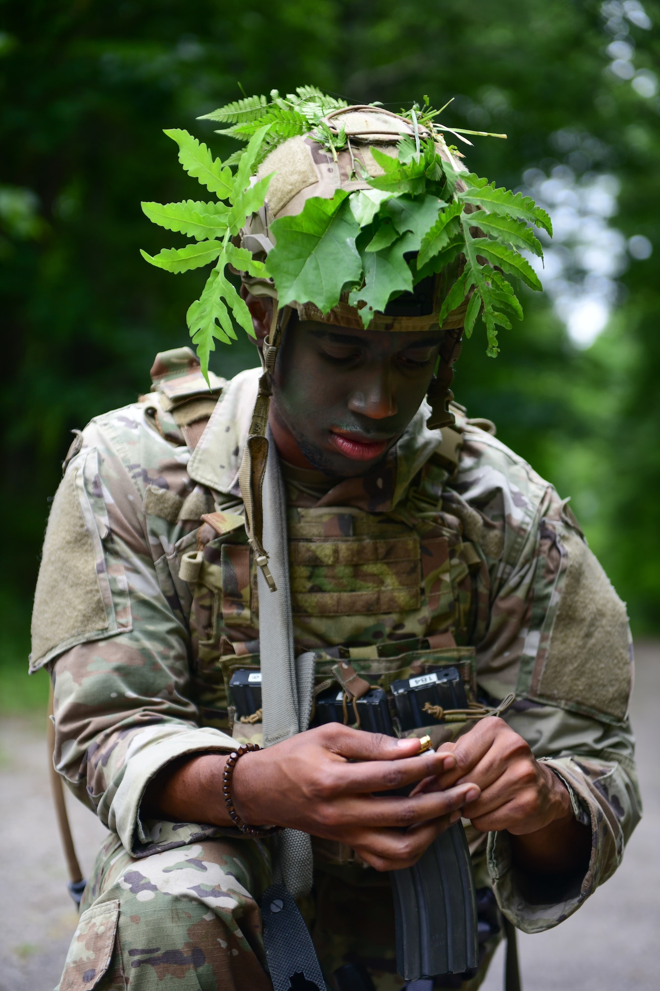 Airman 1st Class Tyven Poole, an Integrated Defense Leadership Course student assigned to the 927th Security Forces Squadron, MacDill Air Force Base, Florida, readies his gear at the start of an area security operations exercise at Camp James A. Garfield Joint Military Training Center, Ohio, July 27, 2022.
