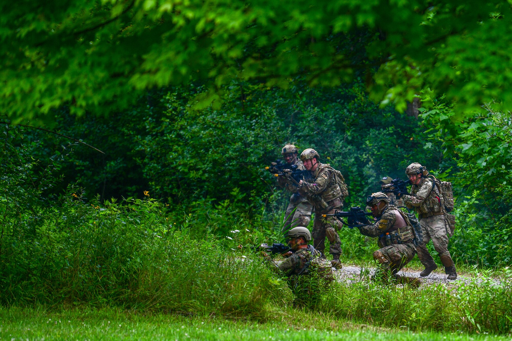 A team of Integrated Defense Leadership Course students assigned to the 927th Security Forces Squadron, MacDill Air Force Base, Florida, engage with opposing force members during an area security operations exercise at Camp James A. Garfield Joint Military Training Center, Ohio, July 27, 2022.