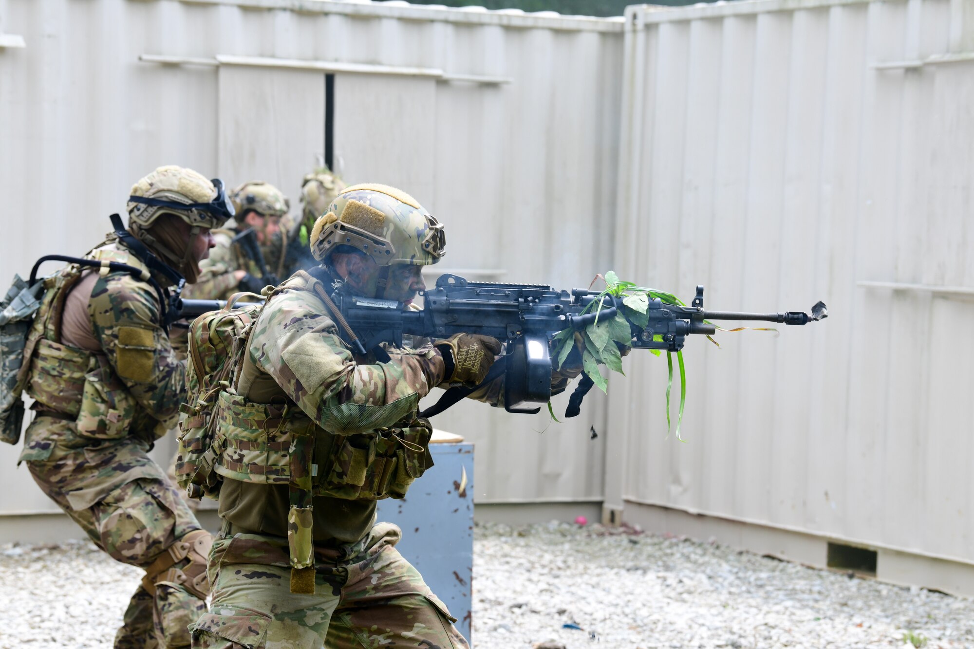 Staff Sgt. Phillip West, an Integrated Defense Leadership Course student assigned to the 927th Security Forces Squadron, MacDill Air Force Base, Florida, fires his M249 light machine gun with blank rounds toward an opposing force ambush during an area security operations exercise at Camp James A. Garfield Joint Military Training Center, Ohio, July 27, 2022.