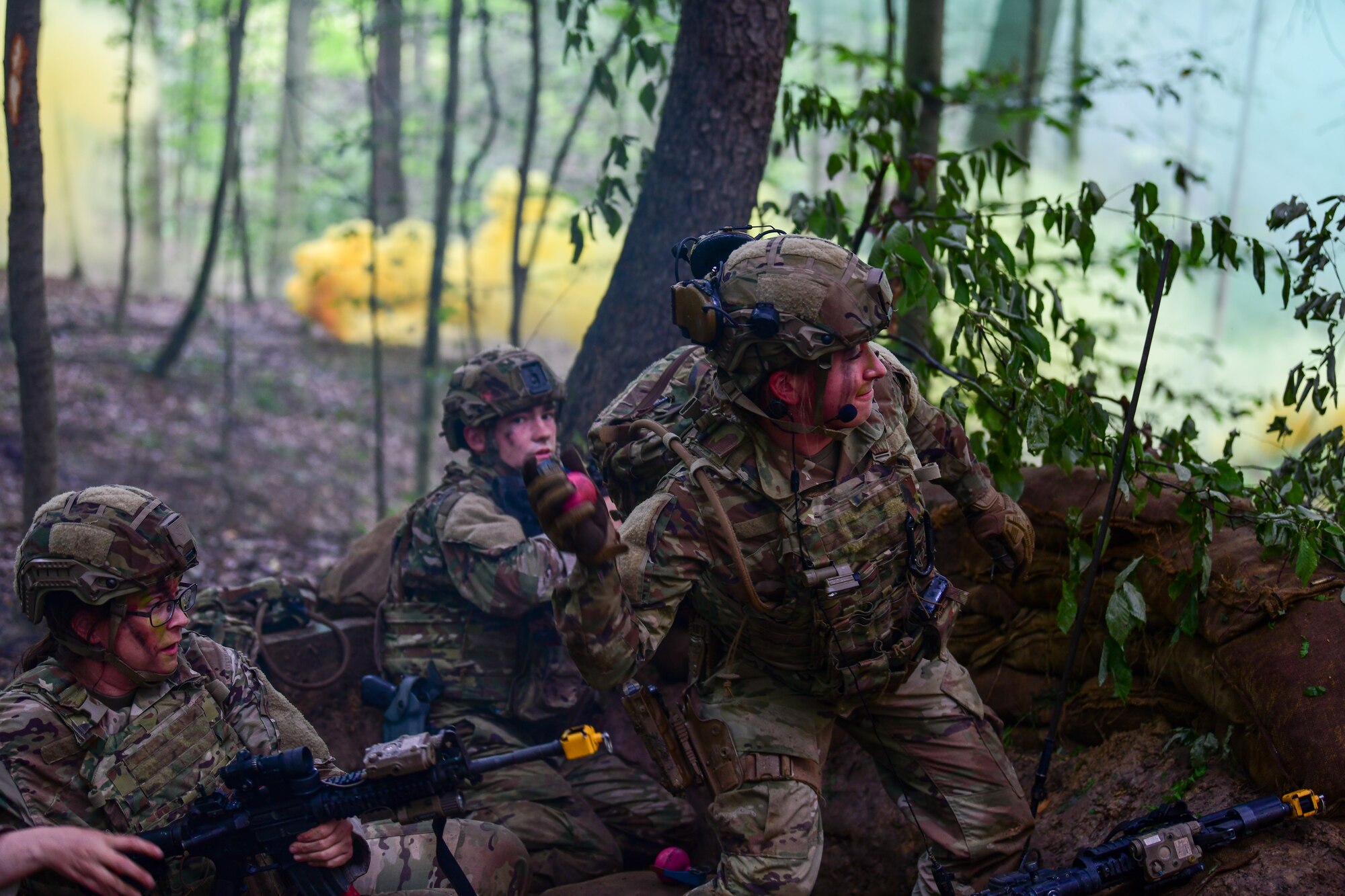 Senior Airman Alissa Fritz, an Integrated Defense Leadership Course student assigned to the 302nd Security Forces Squadron, Peterson Space Force Base, Colorado, throws a training grenade toward opposing force members during a static defense exercise at Camp James A. Garfield Joint Military Training Center, Ohio, July 27, 2022.