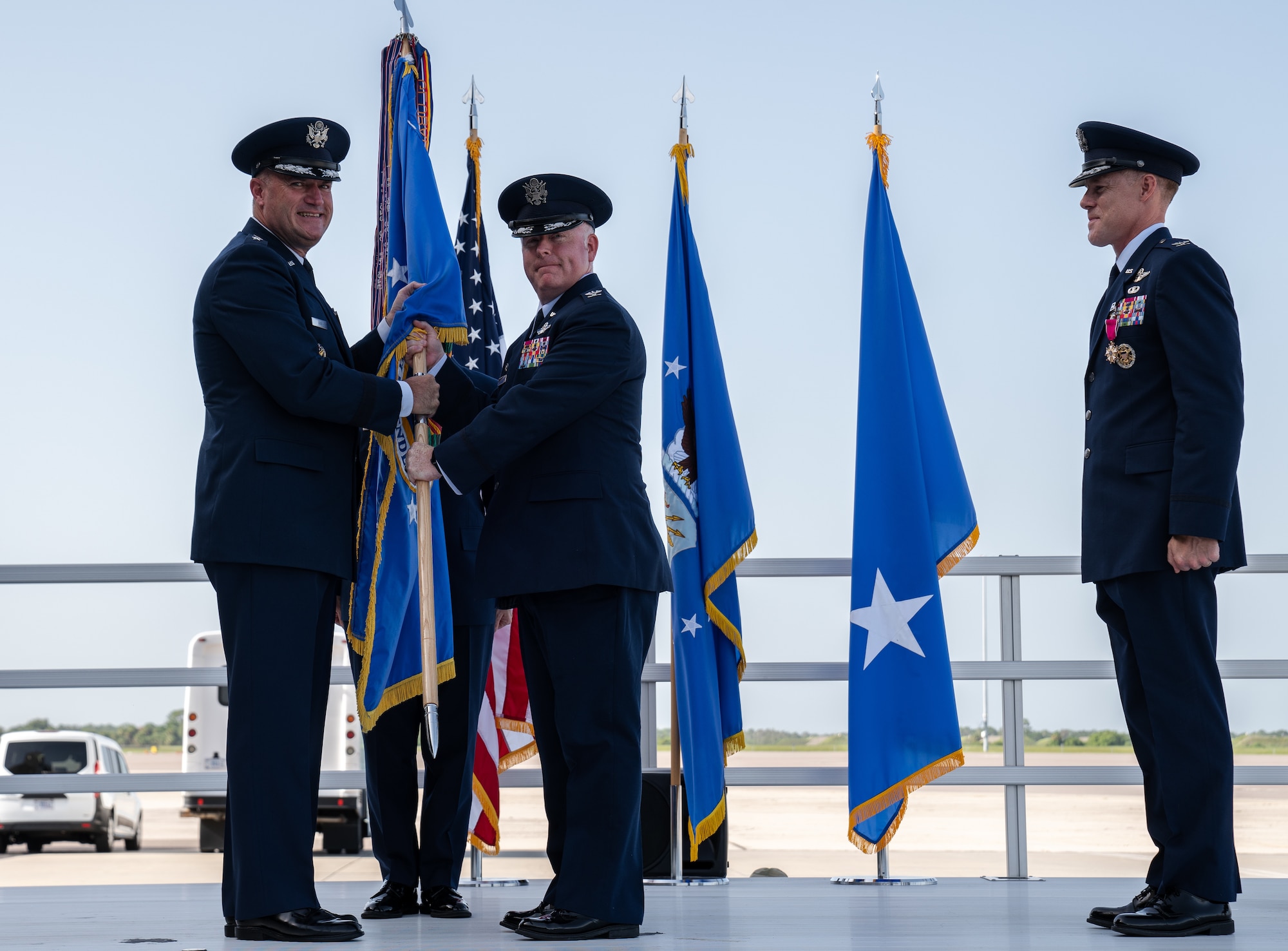 U.S. Air Force Maj. Gen. Kenneth Bibb Jr., 18th Air Force commander, passes the 6th Air Refueling Wing guidon to Col. Adam Bingham, 6th ARW commander, at MacDill Air Force Base, Florida, July 29, 2022.