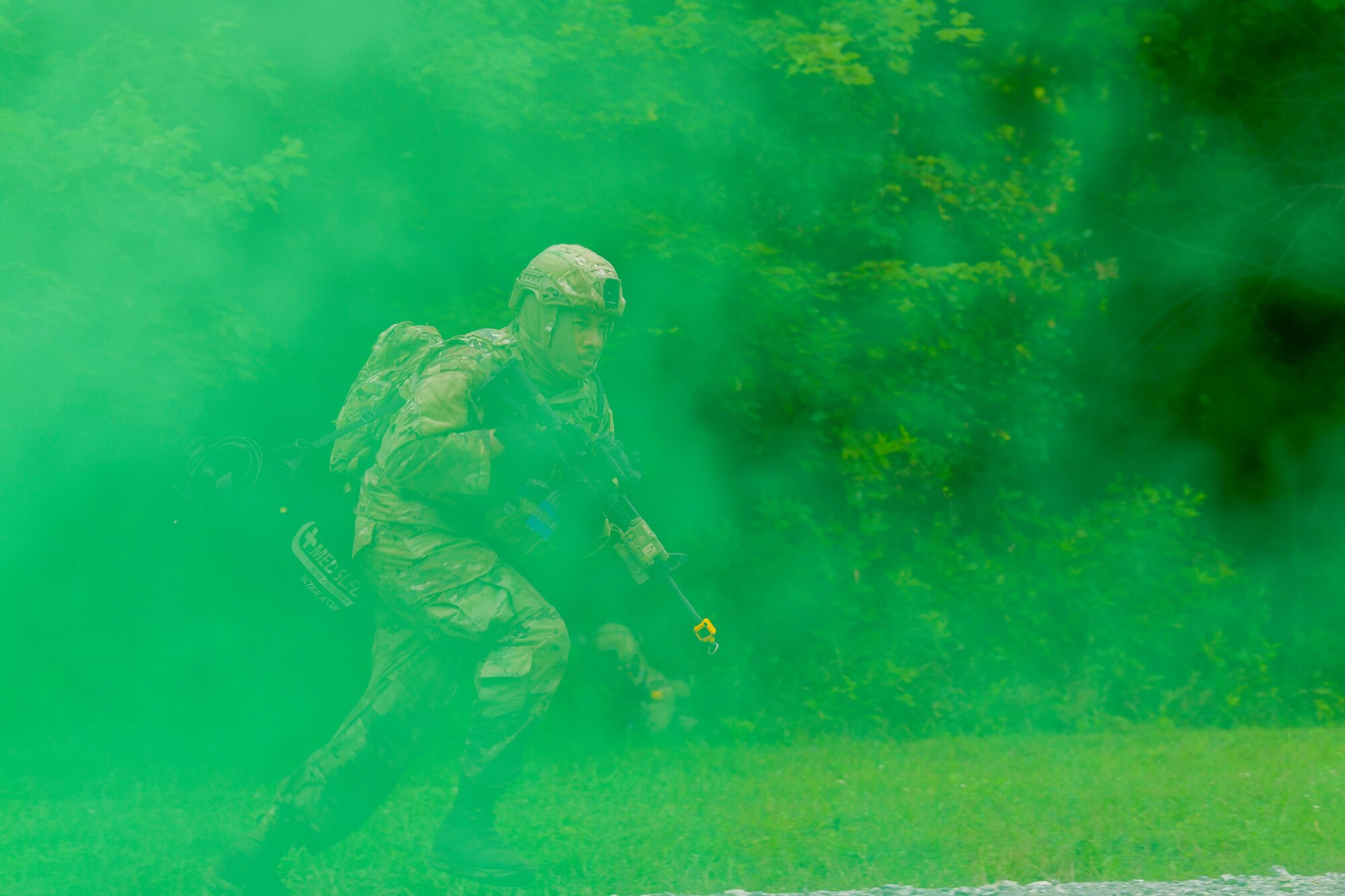 Airman 1st Class Lee Frazier, an Integrated Defense Leadership Course student assigned to the 94th Security Forces Squadron, Dobbins Air Reserve Base, Georgia, moves through smoke cover during an area security operations exercise at Camp James A. Garfield Joint Military Training Center, Ohio, July 27, 2022.