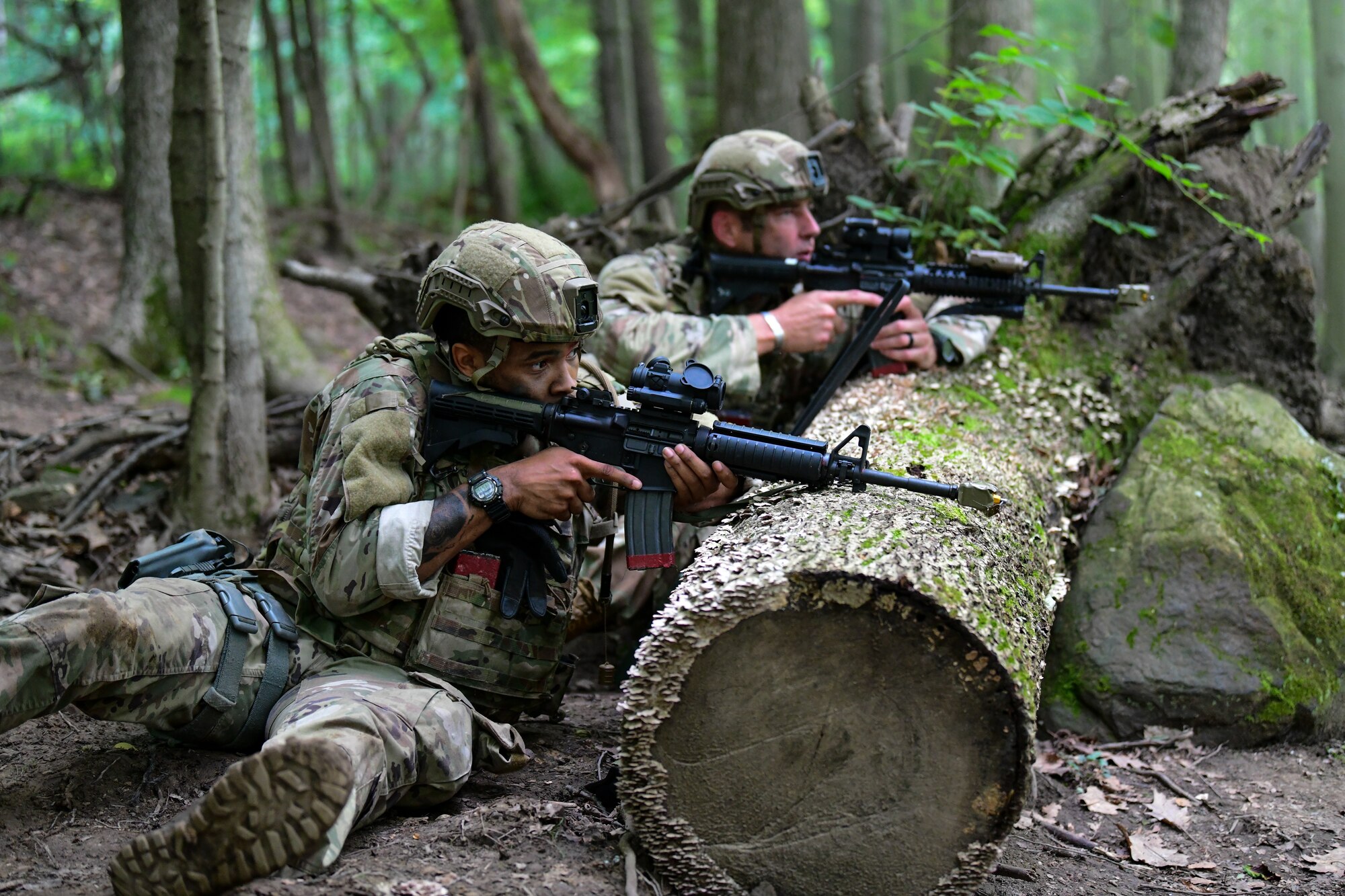 Staff Sgt. Jiquevious Miller and Master Sgt. Justin Waternman, Integrated Defense Leadership Course students assigned to the 307th Security Forces Squadron, Barksdale Air Force Base, Louisiana, watch for movement during a static defense exercise at Camp James A. Garfield Joint Military Training Center, Ohio, July 27, 2022.