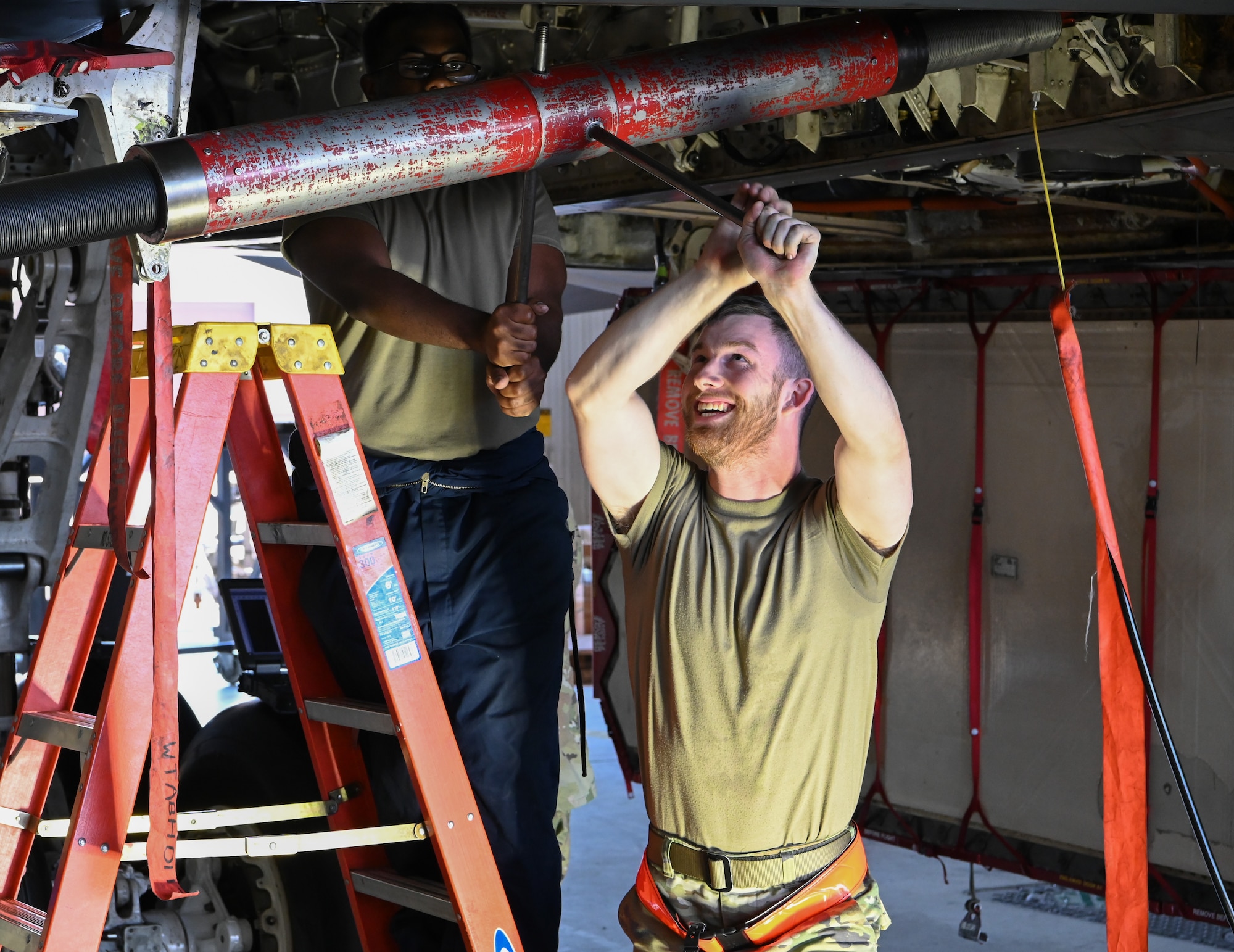 Airmen tighten a component on the B-2 Spirit at Whiteman Air Force Base, Missouri, July 20, 2022. The 509th Maintenance Group conducts inspections on the B-2 so it can be operational anytime, anywhere. (U.S. Air Force photo by Airman 1st Class Joseph Garcia)
