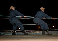 Boatswain’s Mate Dallas Lamarca, left, from West Caldwell, NJ, and Seaman Najma Mohamoud, from Reynoldsburg, OH, heave a mooring line aboard the Lewis B. Puller-class expeditionary sea base USS Hershel "Woody" Williams (ESB 4), July 29, 2022. Hershel “Woody” Williams is rotationally deployed to the U.S. Naval Forces Africa area of operations, employed by U.S. Sixth Fleet, to defend U.S., allied and partner interests.