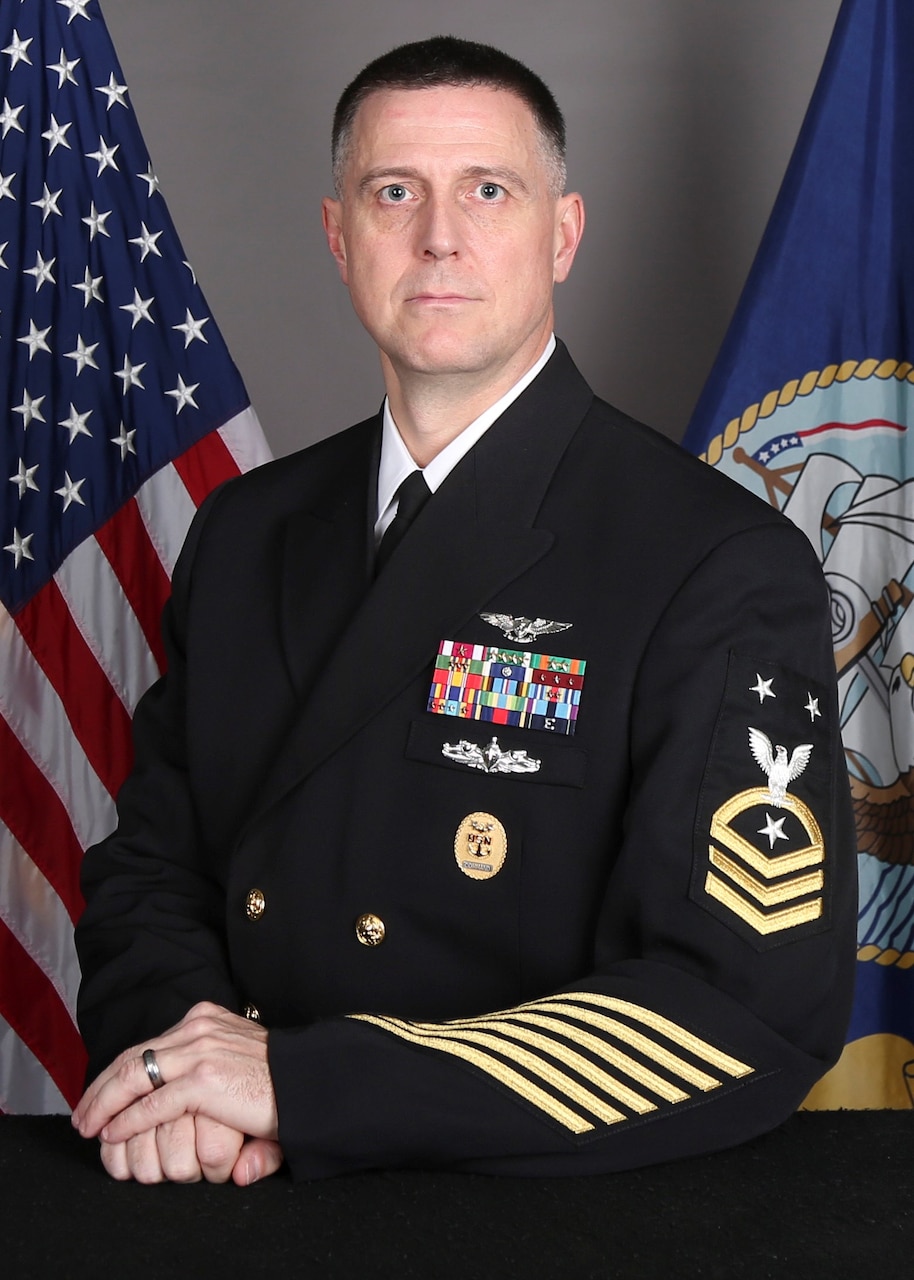 Command Master Chief Brian Happli, Carrier Strike Group 3, sits for a studio portait.