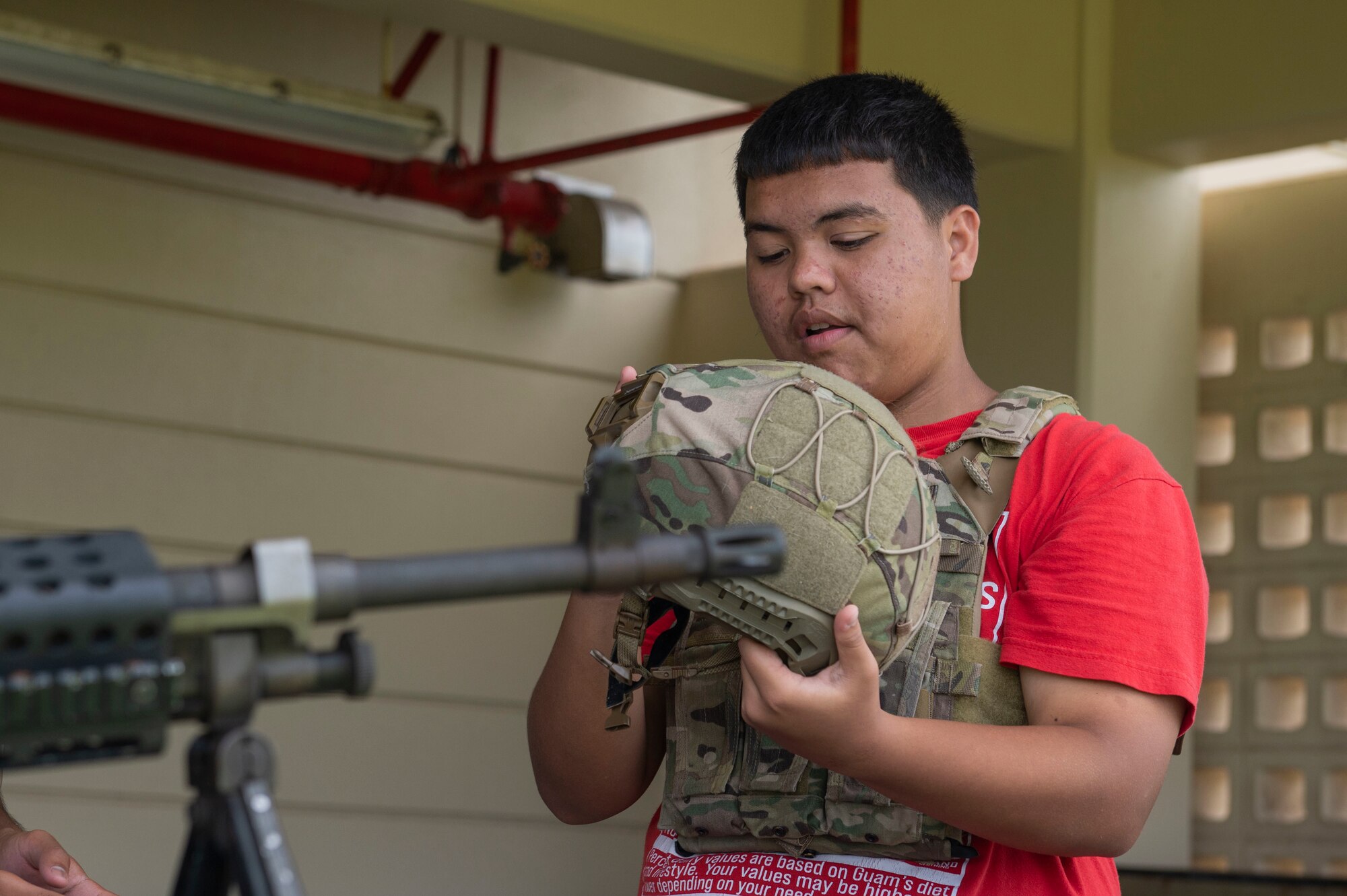 A child puts on military gear