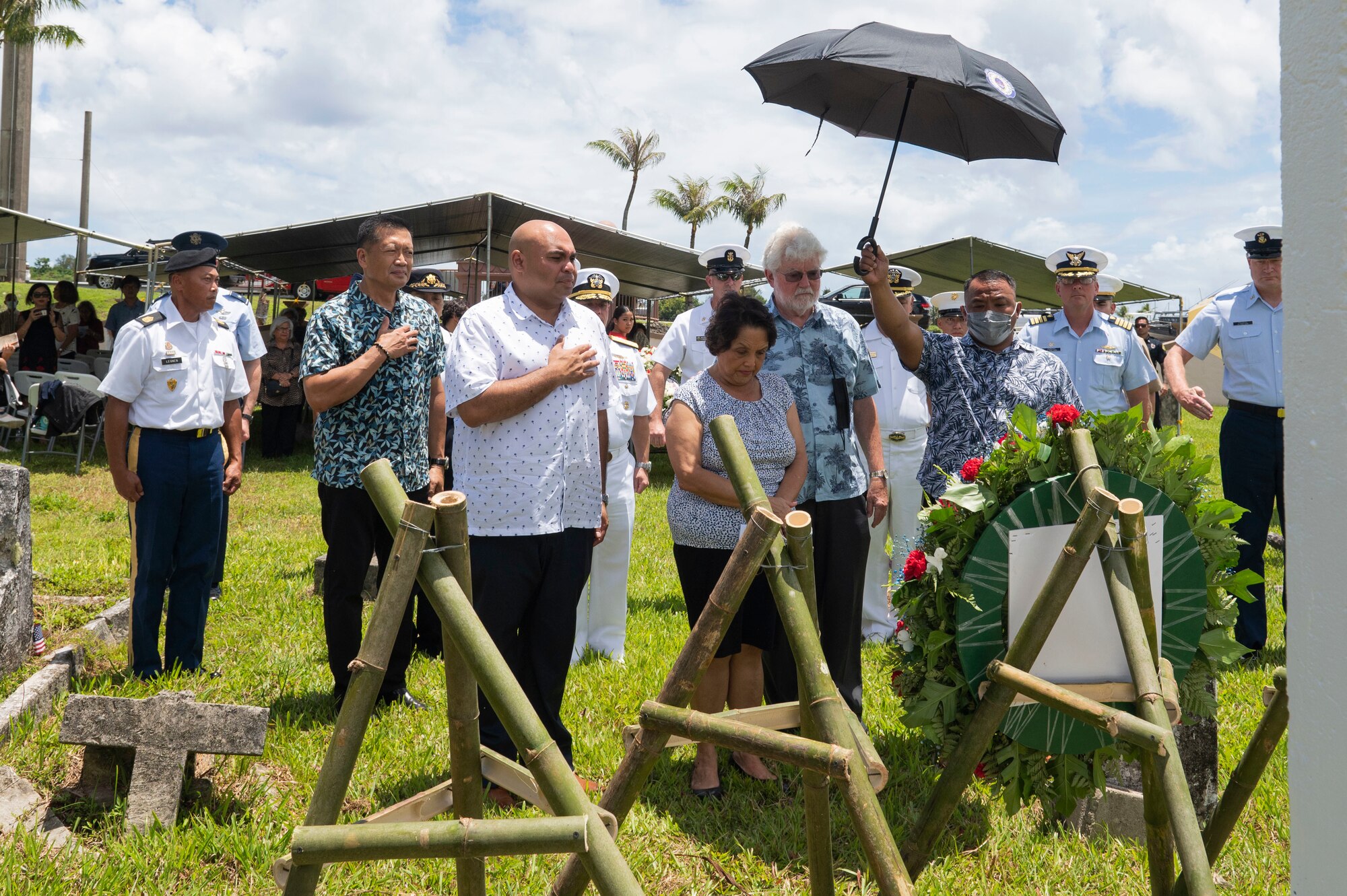 People pay their respects to with a wreath laying