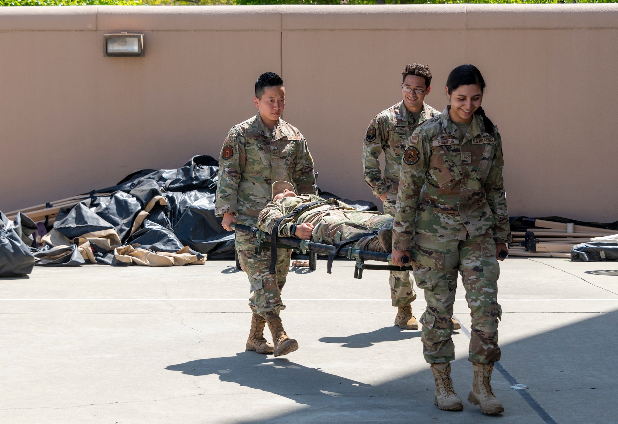 Airmen carry a stretcher.