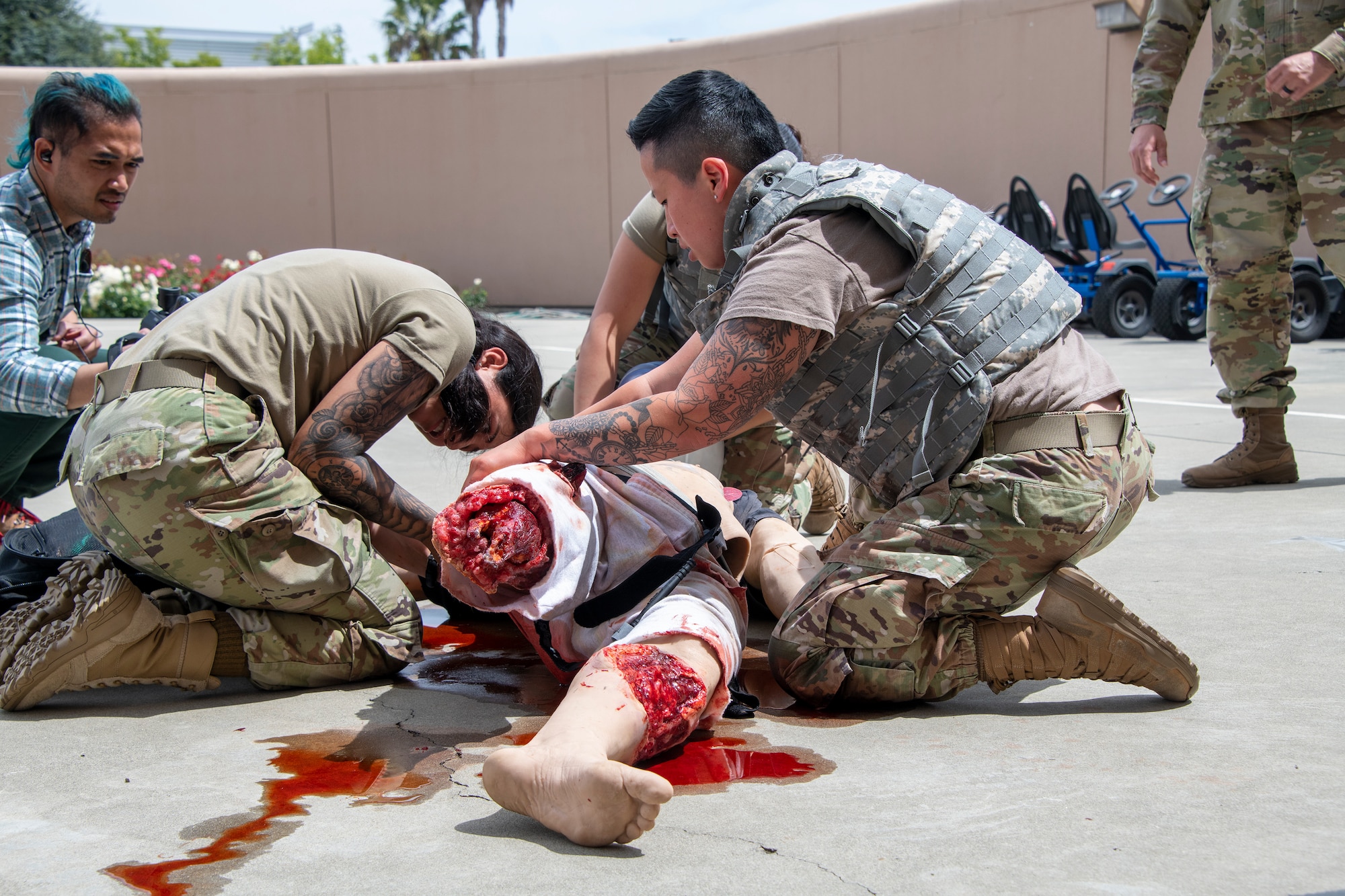 U.S. Airmen participate in medical readiness tactical combat casualty care training with a simulated patient at David Grant USAF Medical Center, Travis Air Force Base, California, April 29, 2022.