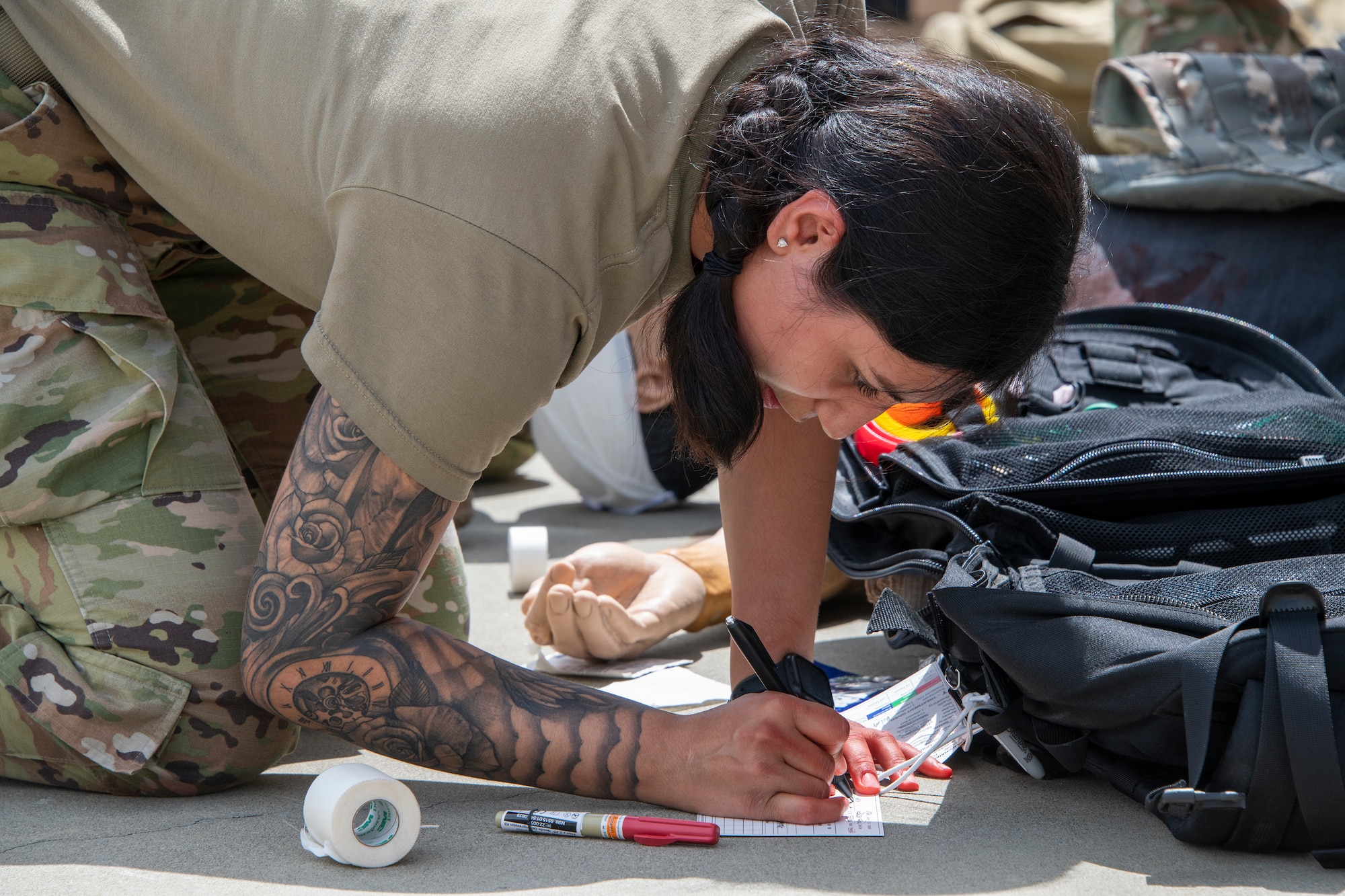 An Airman writes on paper.