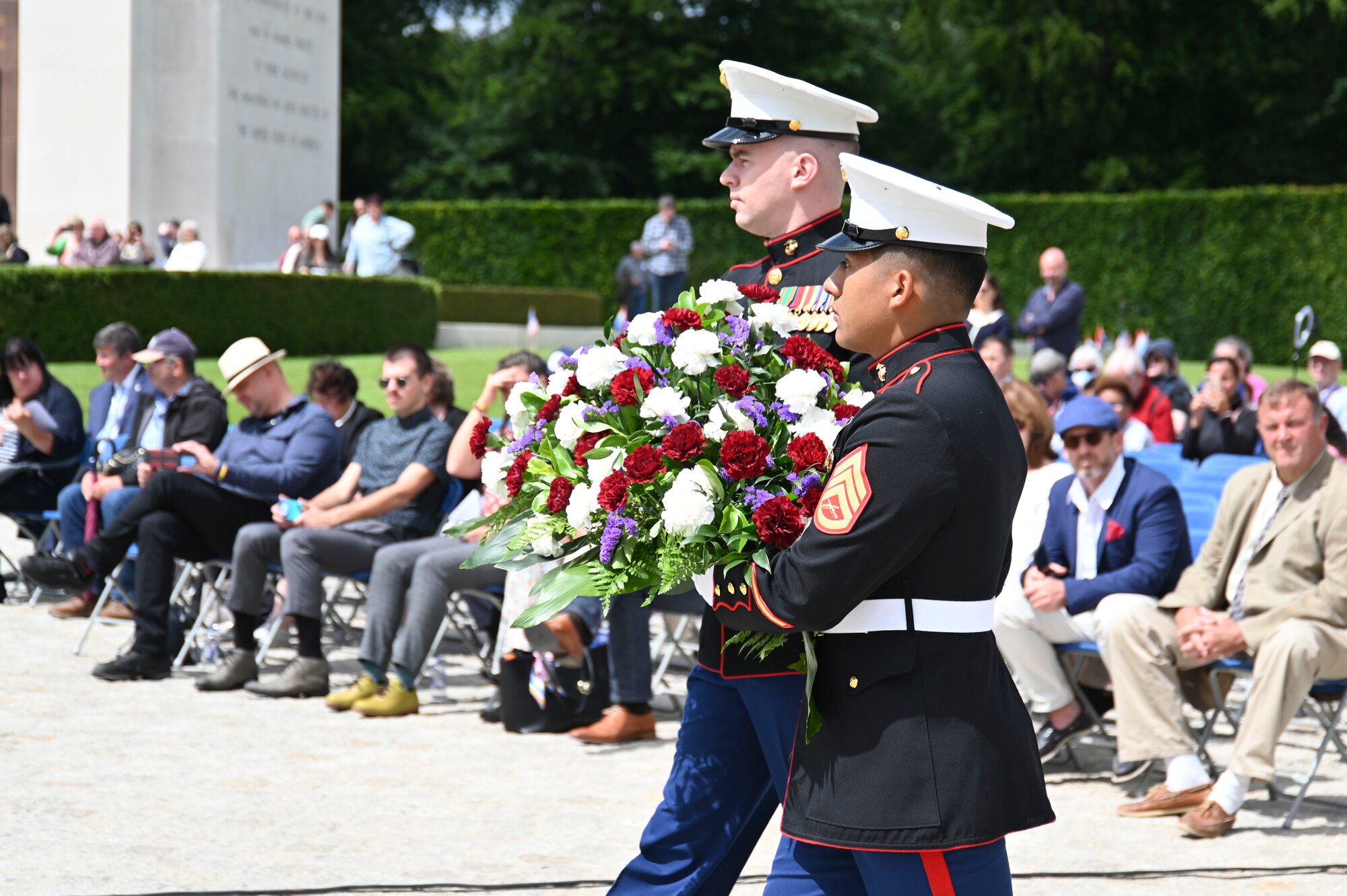 Two U.S. Marines, with the U.S. Luxembourg Embassy, present a wreath during a Memorial Day event at the Luxembourg American Military Cemetery in Luxembourg, May 28, 2022. The ceremony brought together military representatives and hundreds of supporters to recognize the sacrifices made by American service members in support of freedom abroad. (U.S. Air Force photo by Airman 1st Class Jessica Sanchez-Chen)