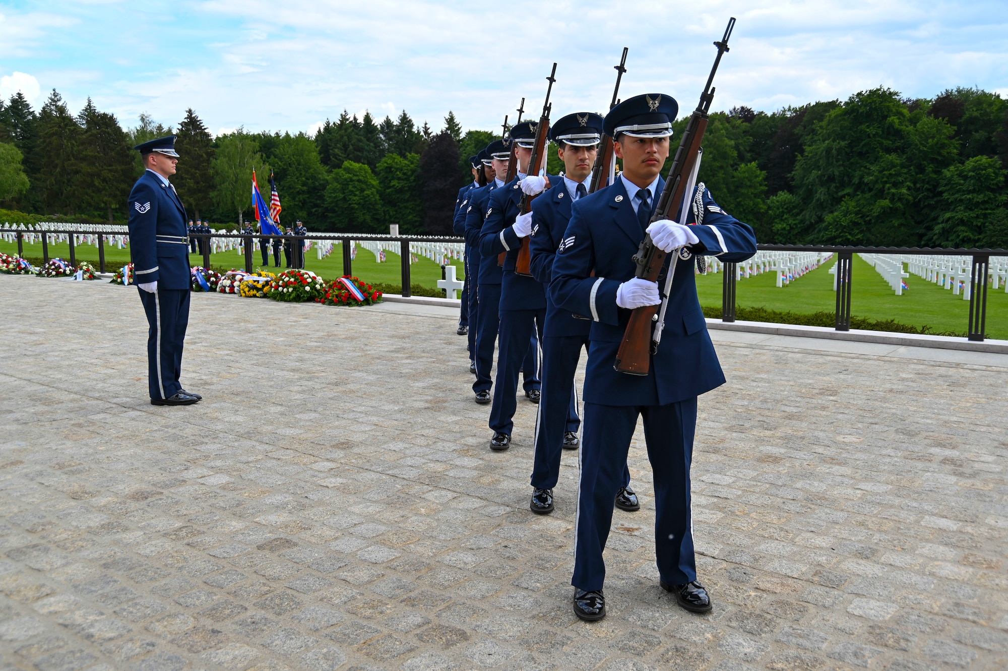 The 786th Force Support Squadron Firing Detail prepare to fire a three-volley salute during a Memorial Day event at the Luxembourg American Military cemetery in Luxembourg on May 28, 2022. The three-volley salute involved seven members firing three times in unison for a total of 21 rounds fired. (U.S. Air Force photo by Airman 1st Class Jessica Sanchez-Chen)