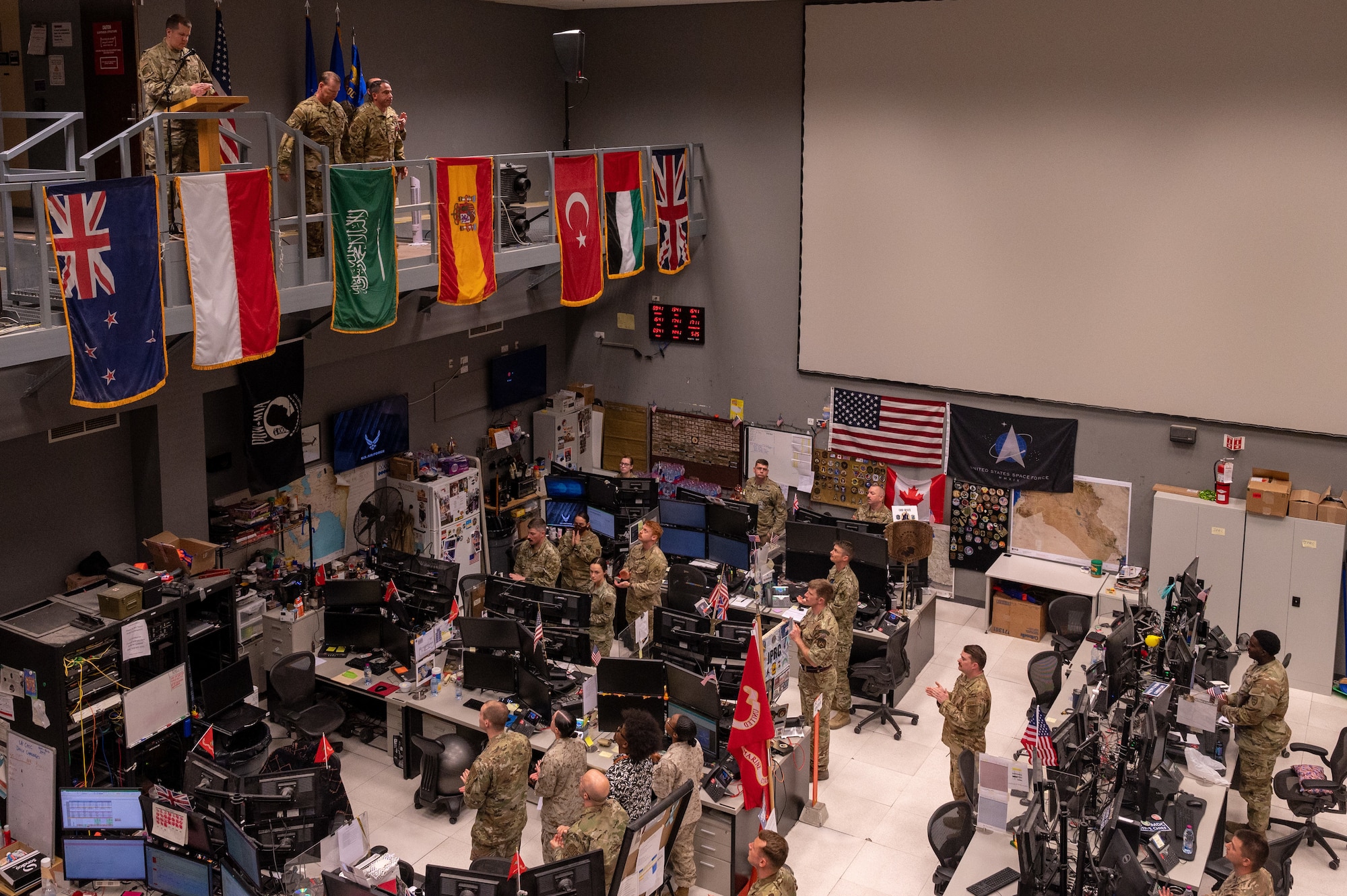 U.S. Air Force Master Sgt. Kenneth Guthrie, master of ceremonies, speaks at the 609th Air Operations Center change of command ceremony at the Combined Air Operations Center at Al Udeid Air Base, Qatar, May 25, 2022. At the ceremony, U.S. Air Force Col. Joshua Koslov relinquished command of the 609th AOC to U.S. Air Force Col. Kevin M. Ogle. The CAOC is comprised of a joint and coalition team that executes day-to-day combined air and space operations and provides rapid reaction, positive control, coordination, and de-confliction of weapon systems. (U.S. Air Force photo by Senior Airman Dominic Tyler)
